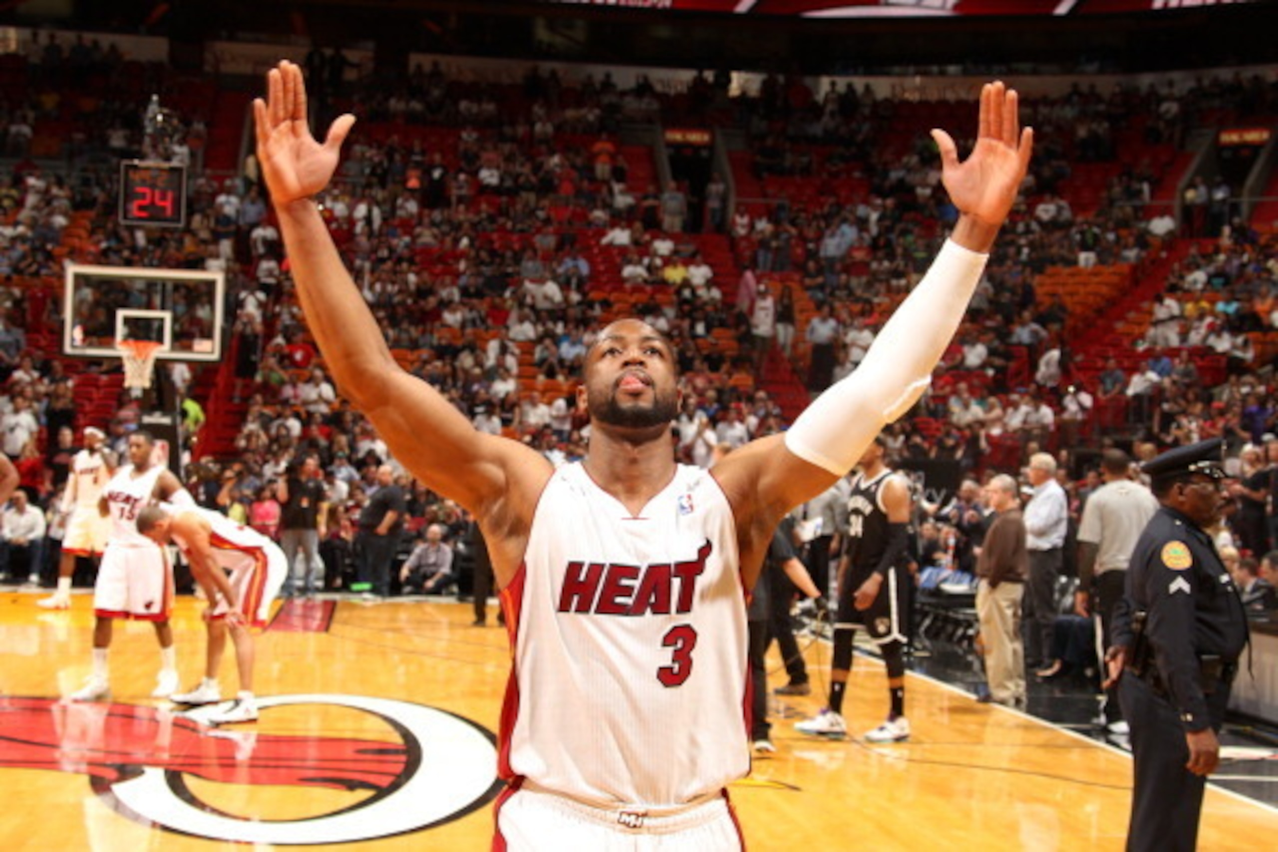 MIAMI, FL - March 12:   Dwyane Wade #3 of the Miami Heat celebrates against the Brooklyn Nets at the American Airlines Arena in Miami, Florida on March 12 2014. NOTE TO USER: User expressly acknowledges and agrees that, by downloading and/or using this ph