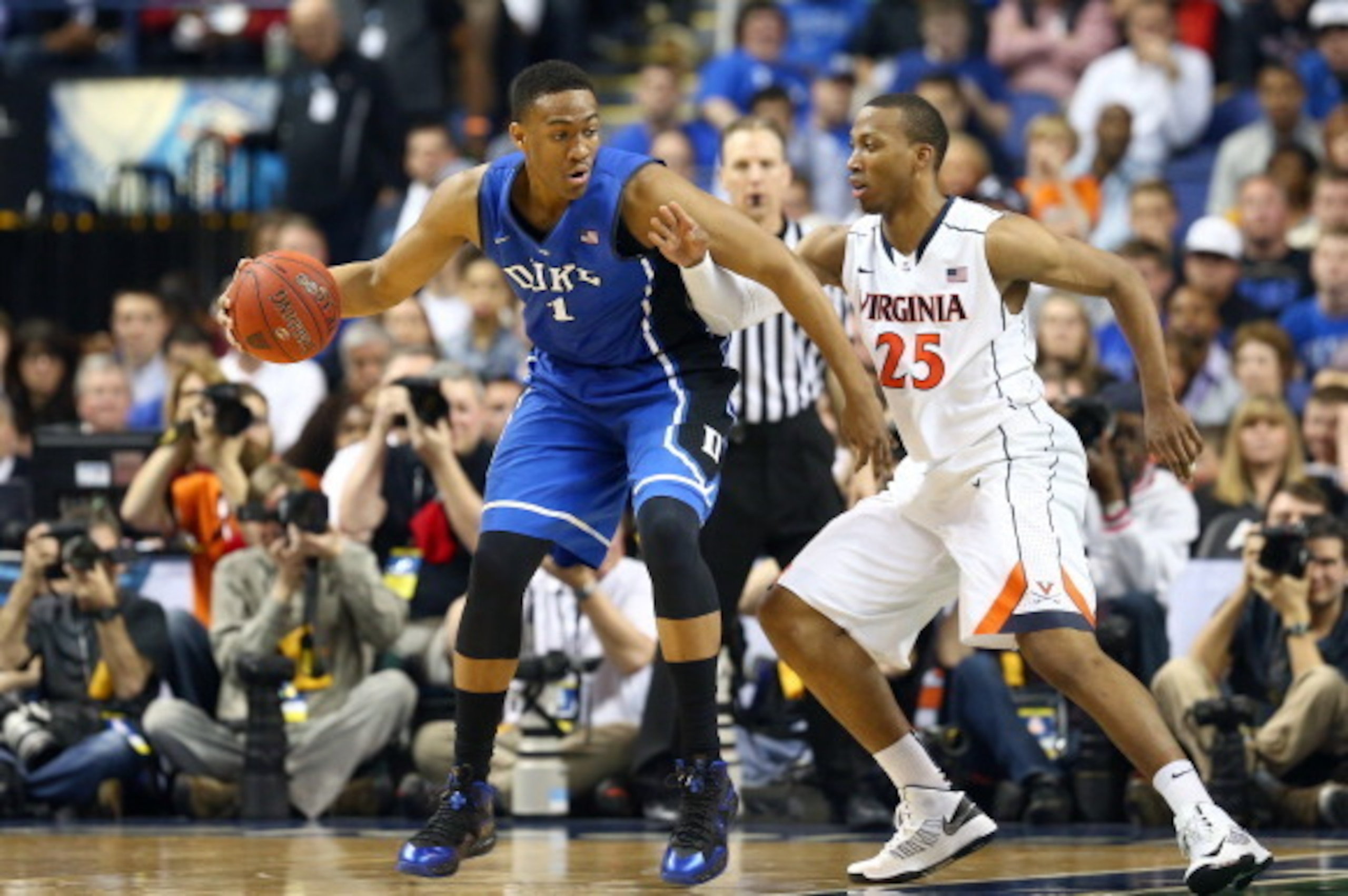GREENSBORO, NC - MARCH 16:  Jabari Parker #1 of the Duke Blue Devils is covered by Akil Mitchell #25 of the Virginia Cavaliers during the finals of the 2014 Men's ACC Basketball Tournament at Greensboro Coliseum on March 16, 2014 in Greensboro, North Caro