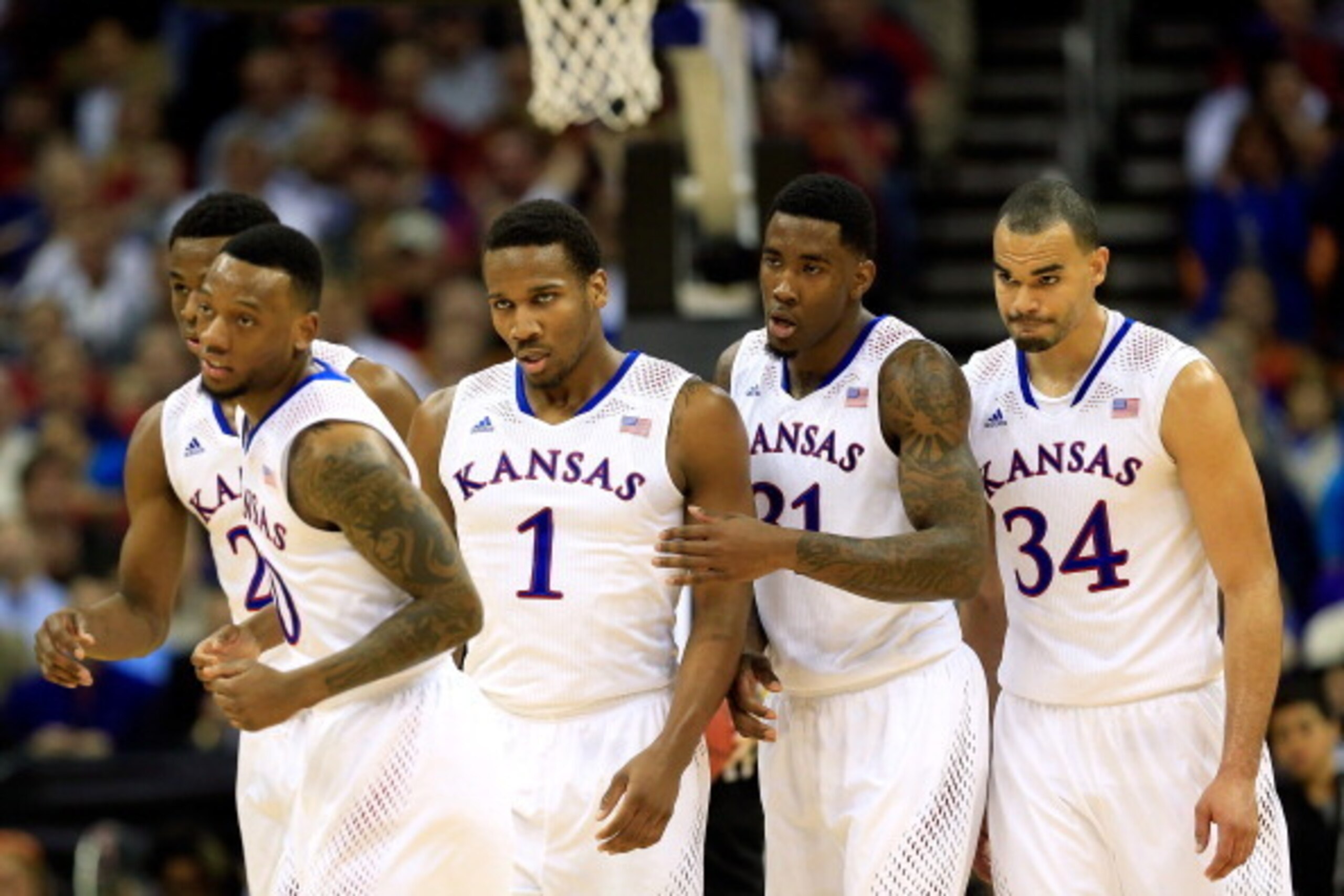 KANSAS CITY, MO - MARCH 13: Andrew Wiggins #22, Naadir Tharpe #10, Wayne Selden, Jr. #1, Jamari Traylor #31, and Perry Ellis #34 of the Kansas Jayhawks walk toward the bench during a timeout in the Big 12 Basketball Tournament quarterfinal game against t KANSAS CITY, MO - MARCH 13: Andrew Wiggins #22, Naadir Tharpe #10, Wayne Selden, Jr. #1, Jamari Traylor #31, and Perry Ellis #34 of the Kansas Jayhawks walk toward the bench during a timeout in the Big 12 Basketball Tournament quarterfinal game against t