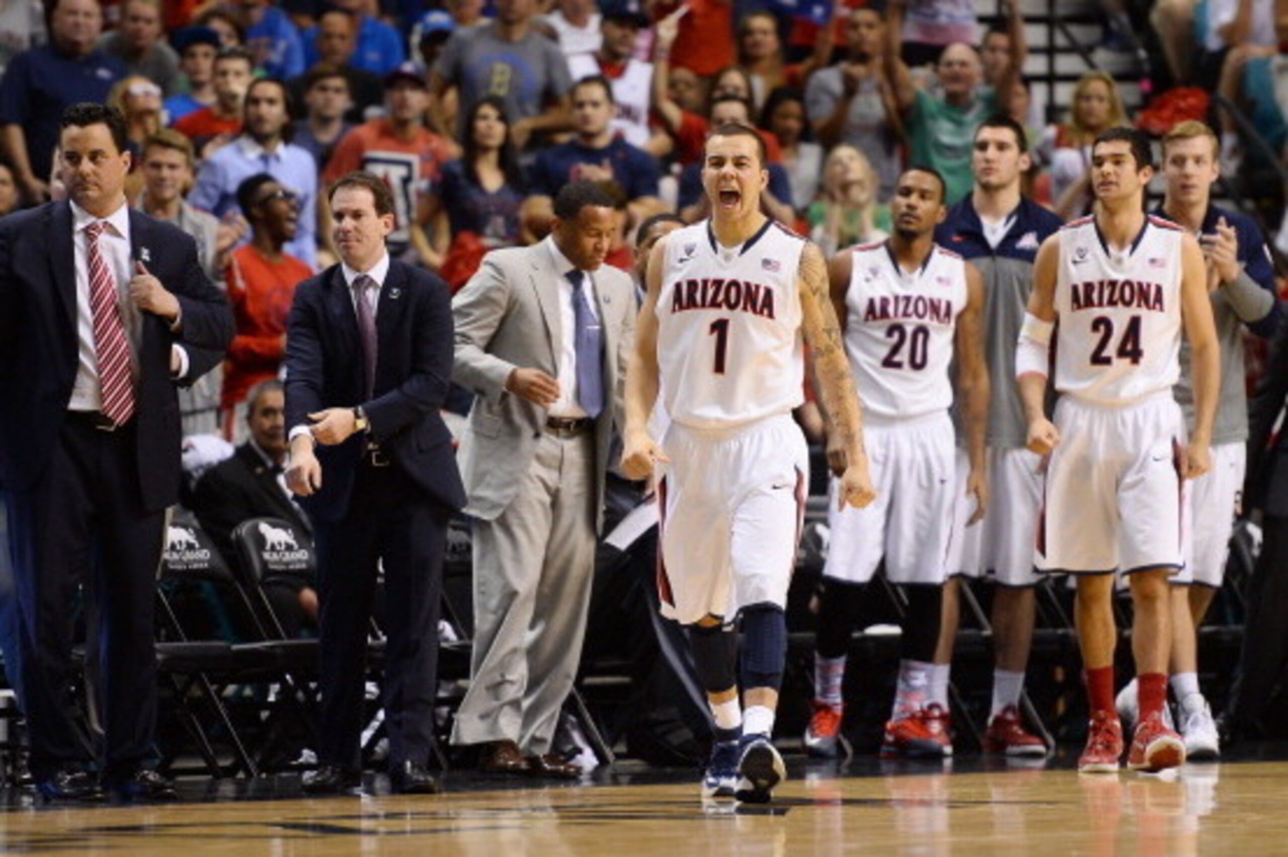 LAS VEGAS, NV - MARCH 15:  Gabe York #1 of the Arizona Wildcats reacts as head coach Sean Miller (L) and teammates Jordin Mayes #20 and Elliott Pitts #24 look on during a timeout in the championship game of the Pac-12 Basketball Tournament against the UCL
