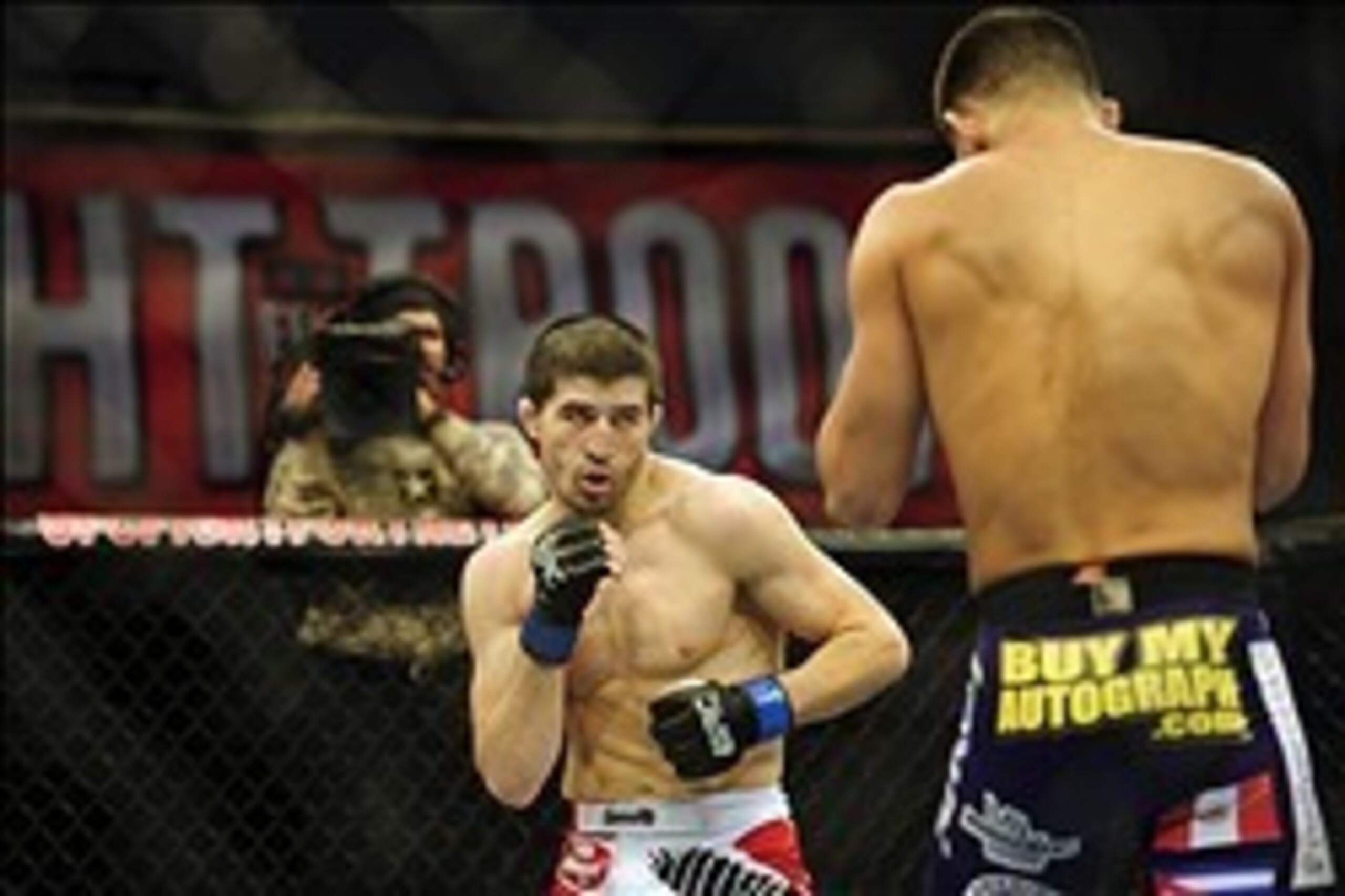 Nov 6, 2013; Fort Campbell, KY, USA; Jorge Masvidal (red gloves) fights Rustam Khabilov (blue gloves) in the lightweight bout during UFC Fight for the Troops at Fort Campbell. Mandatory Credit: Joshua Lindsey-USA TODAY Sports