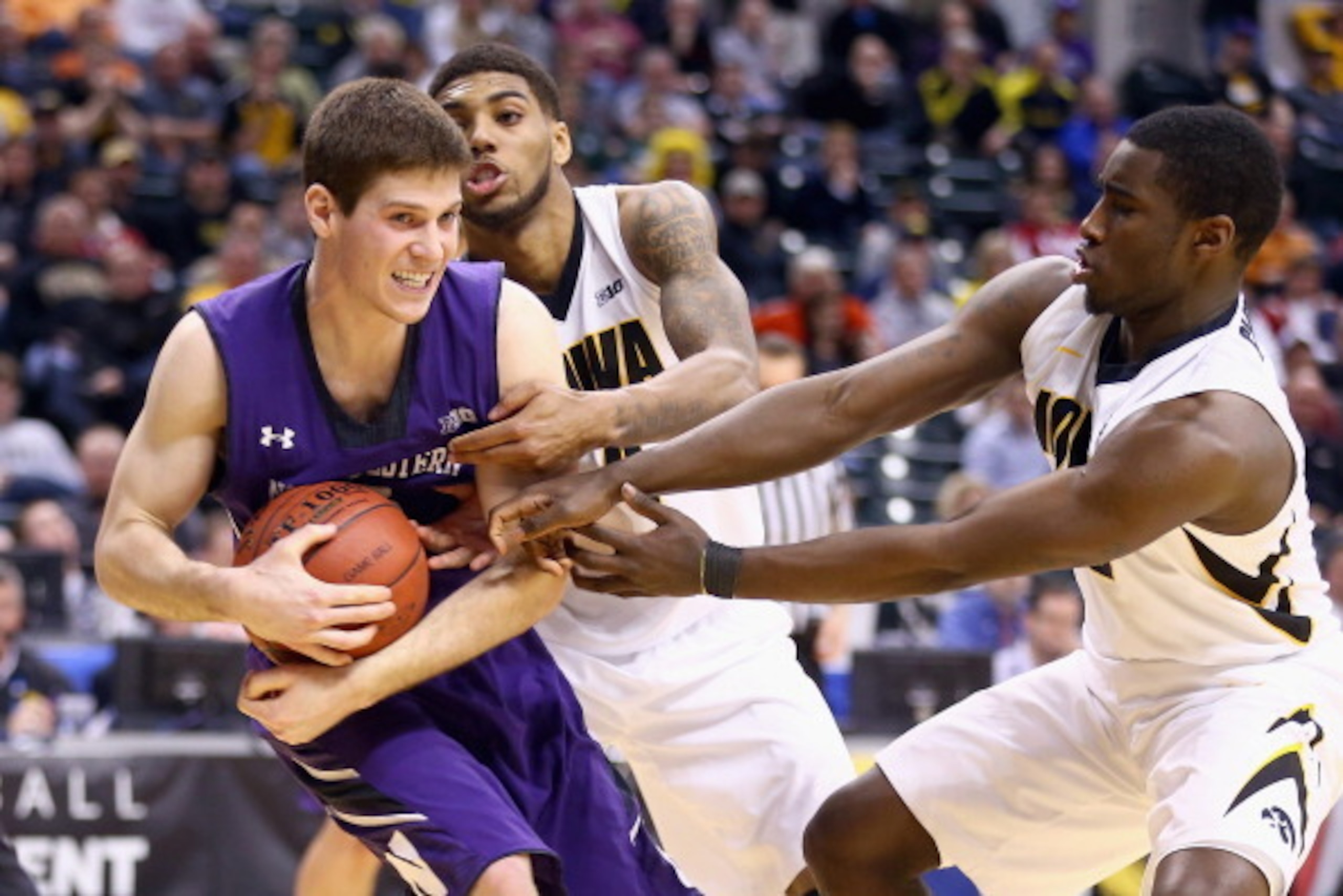 INDIANAPOLIS, IN - MARCH 13:  Dave Sobolewski #3 of the Northwestern Wildcats grabs a rebound in the game against the Iowa Hawkeyes during the first round of the Big Ten Basketball Tournament at Bankers Life Fieldhouse on March 13, 2014 in Indianapolis, I