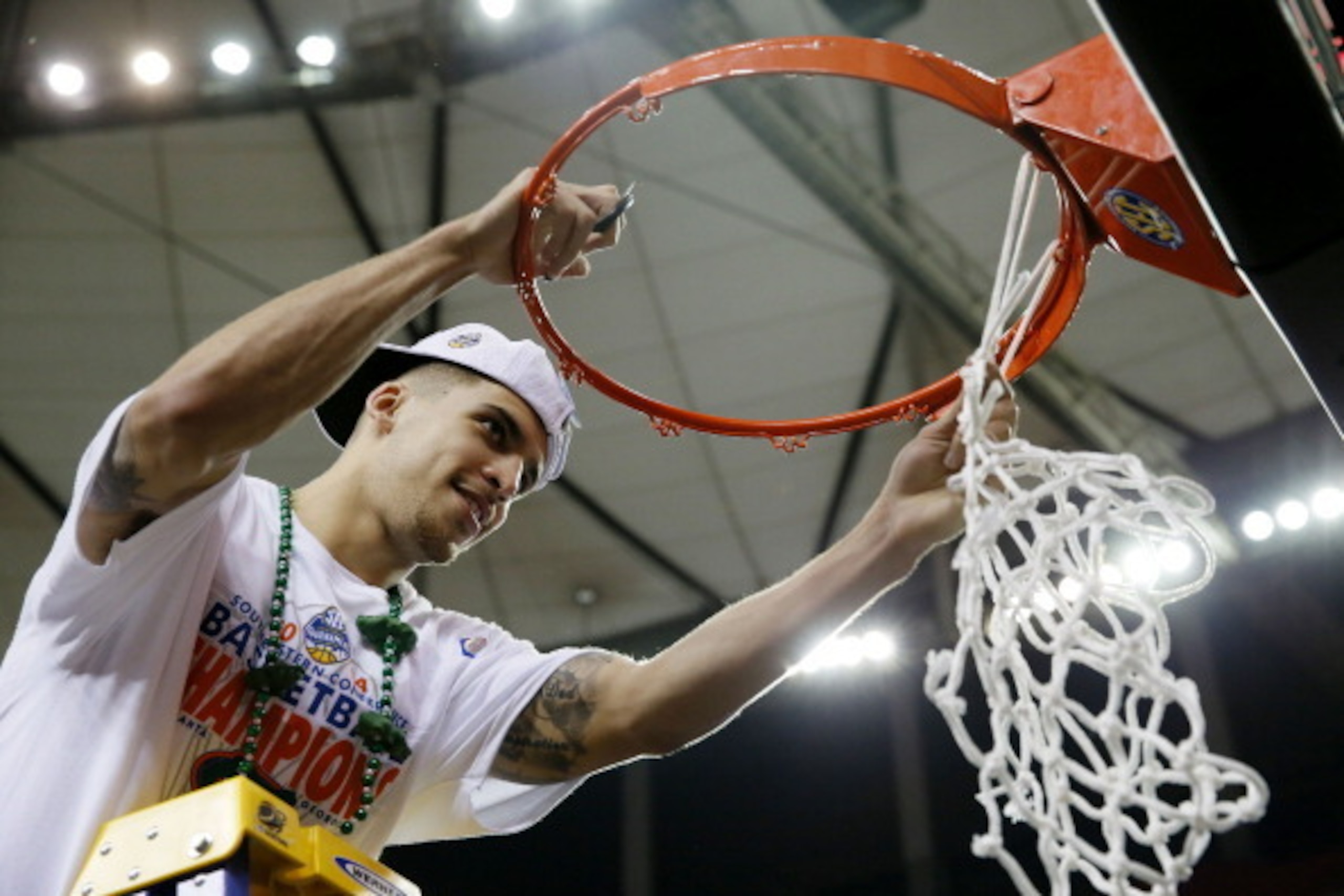 ATLANTA, GA - MARCH 16:  Scottie Wilbekin #5 of the Florida Gators celebrates by cutting down the net after their 61 to 60 win over the Kentucky Wildcats in the Championship game of the 2014 Men's SEC Basketball Tournament at Georgia Dome on March 16, 201