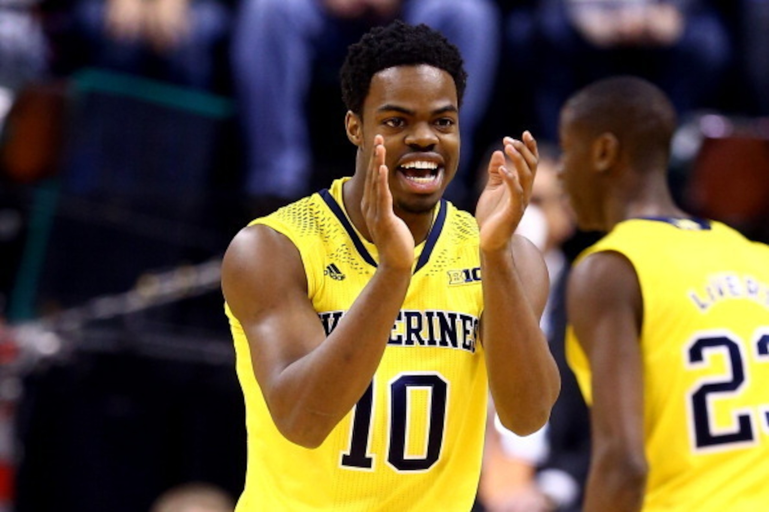INDIANAPOLIS, IN - MARCH 16:  Derrick Walton Jr. #10 of the Michigan Wolverines reacts against the Michigan State Spartans during the 2014 Big Ten Men's Championship at Bankers Life Fieldhouse on March 16, 2014 in Indianapolis, Indiana.  (Photo by Andy Ly