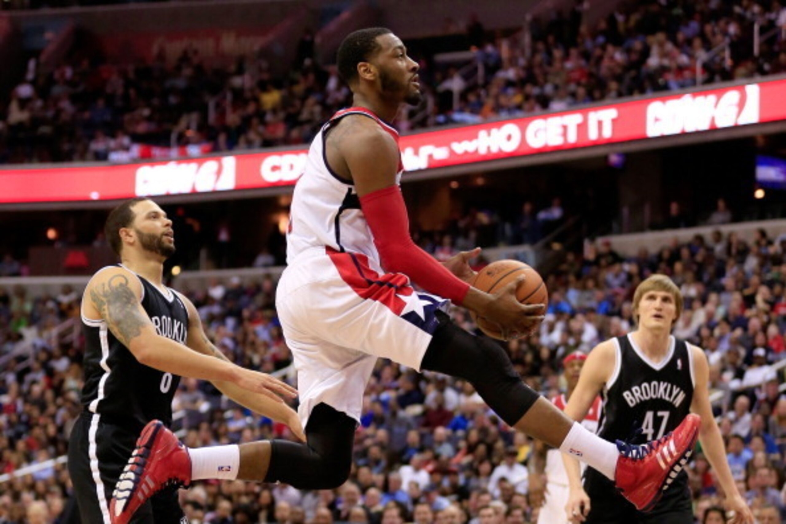 WASHINGTON, DC - MARCH 15:  John Wall #2 of the Washington Wizards puts up a shot during the second half of the Wizards 101-94 win over the Brooklyn Nets at Verizon Center on March 15, 2014 in Washington, DC. NOTE TO USER: User expressly acknowledges and 