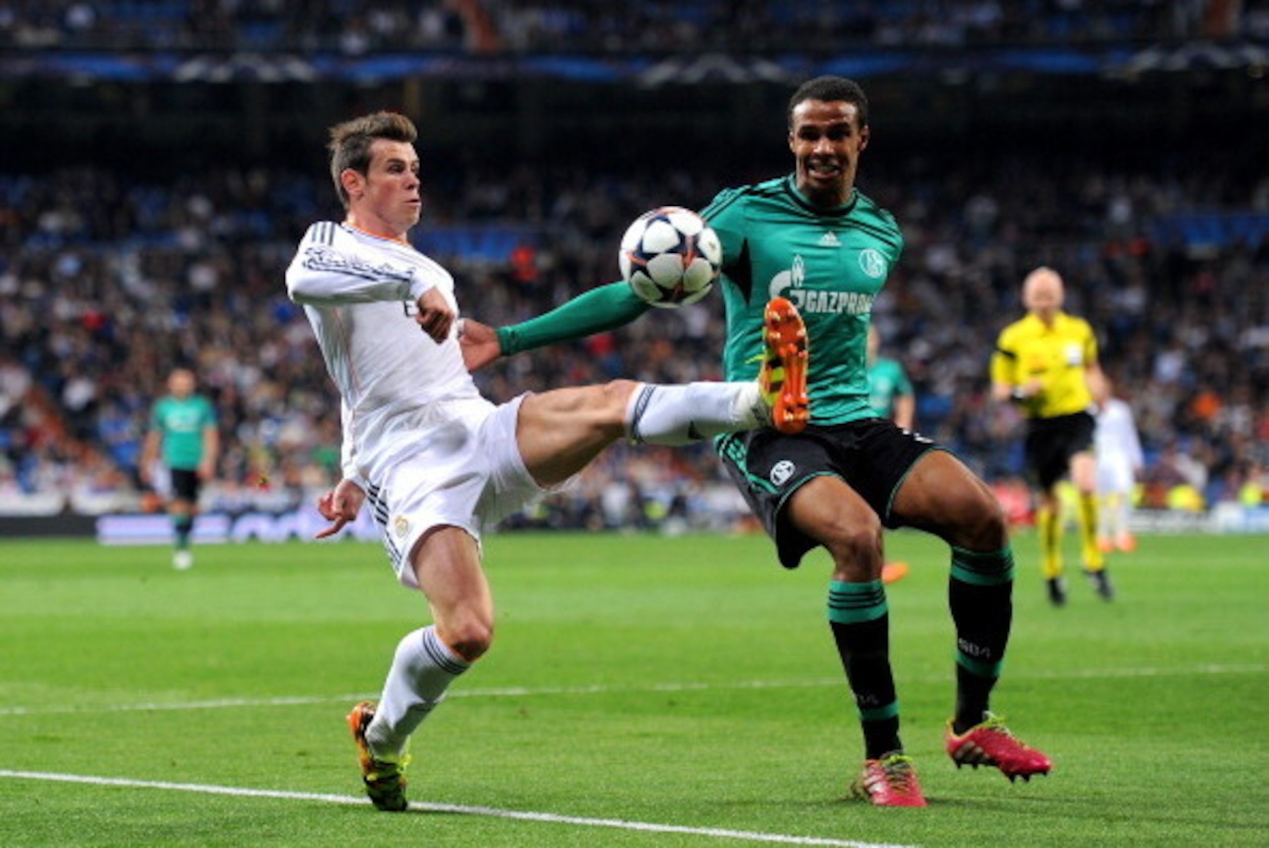 MADRID, SPAIN - MARCH 18:  Gareth Bale of Real Madrid controls the ball under pressure from Joel Matip of Schalke uring the UEFA Champions League Round of 16, second leg match between Real Madrid and FC Schalke 04 at Estadio Santiago Bernabeu on March 18,