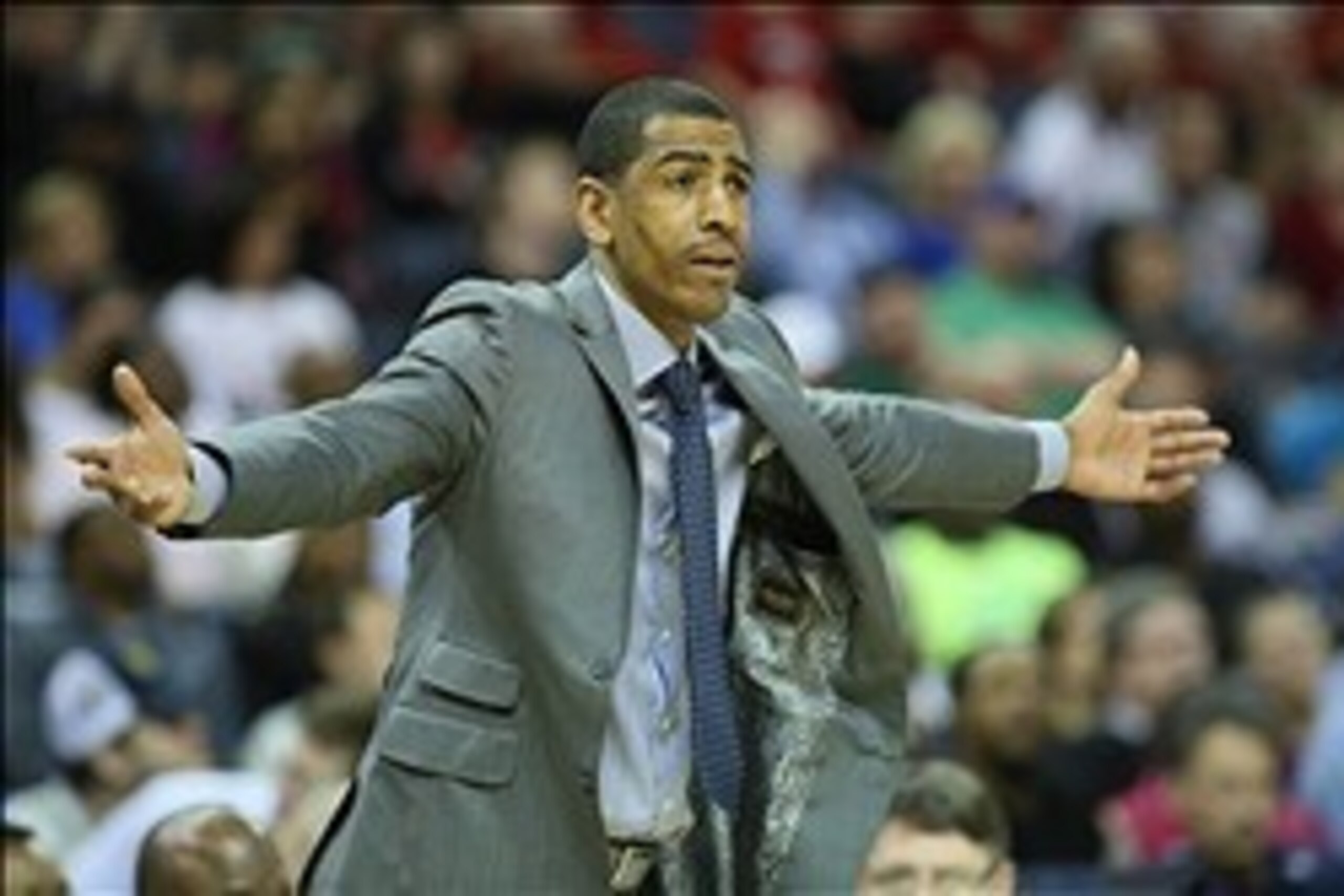 Mar 15, 2014; Memphis, TN, USA; Connecticut Huskies head coach Kevin Ollie gestures from the sidelines during the second half against the Louisville Cardinals in final of the American Athletic Conference college basketball tournament at FedEx Forum. The C