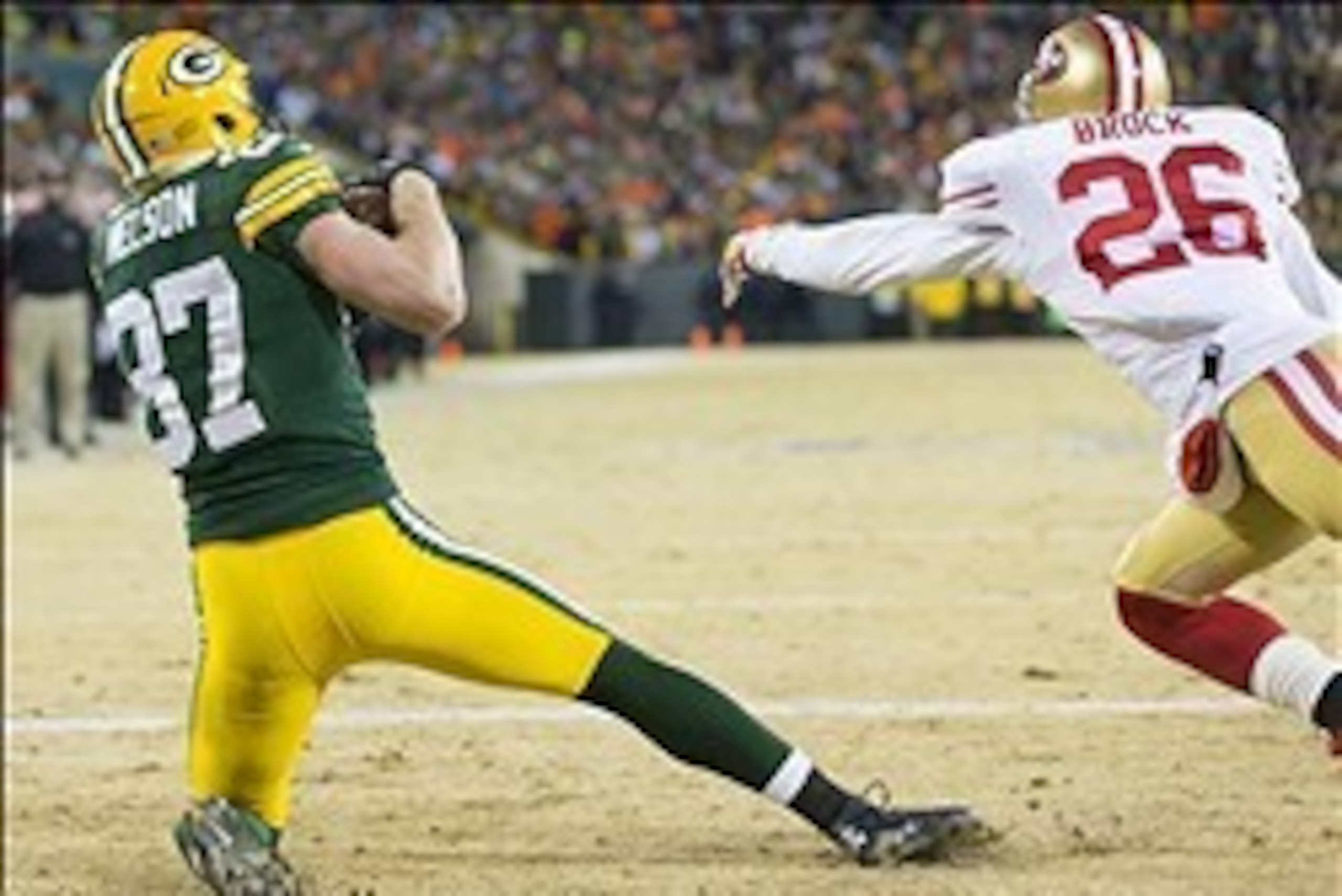 Jan 5, 2014; Green Bay, WI, USA; Green Bay Packers wide receiver Jordy Nelson (87) catches a touchdown pass as San Francisco 49ers cornerback Tramaine Brock (26) defends during the second quarter of the 2013 NFC wild card playoff football game at Lambeau 