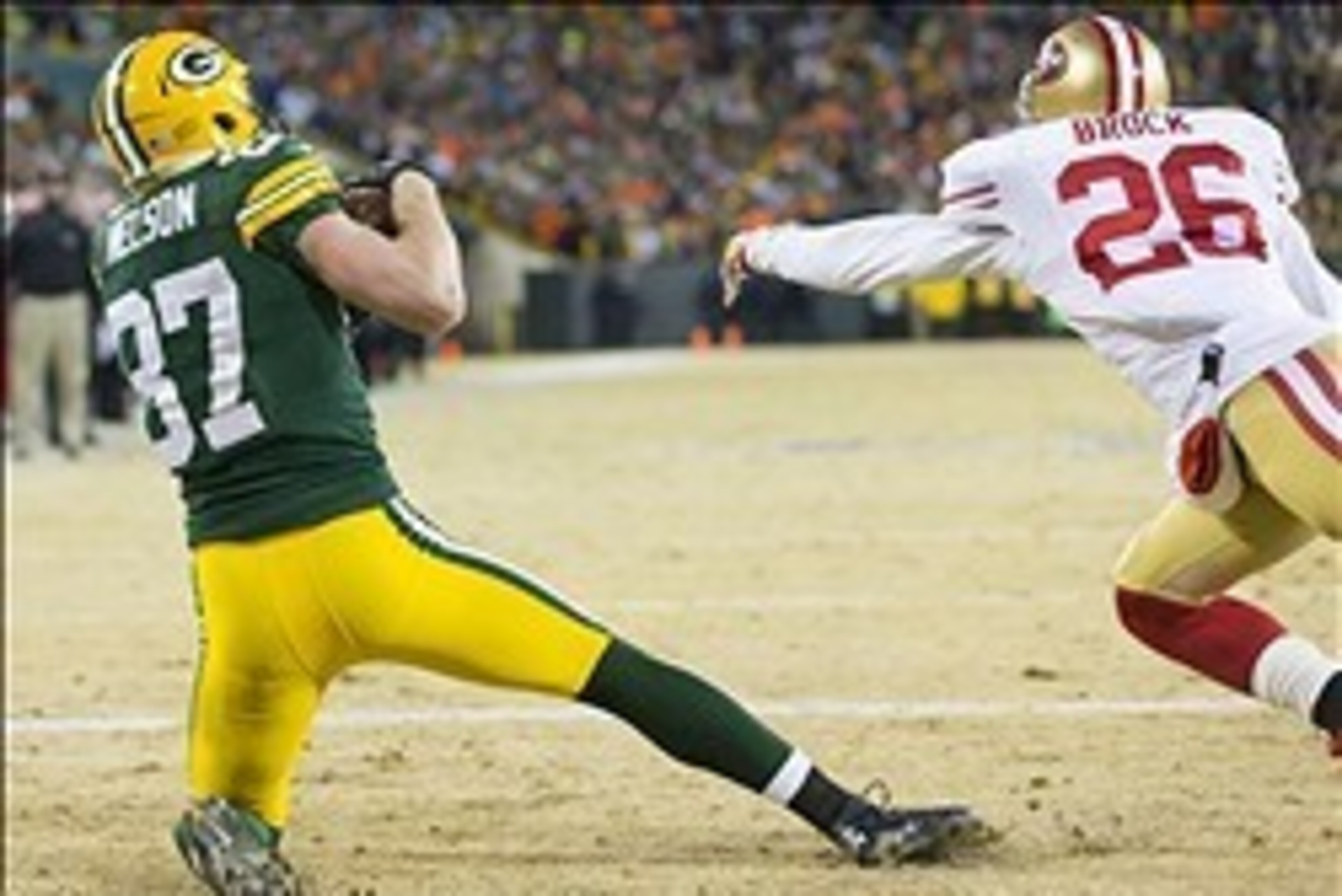 Jan 5, 2014; Green Bay, WI, USA; Green Bay Packers wide receiver Jordy Nelson (87) catches a touchdown pass as San Francisco 49ers cornerback Tramaine Brock (26) defends during the second quarter of the 2013 NFC wild card playoff football game at Lambeau 