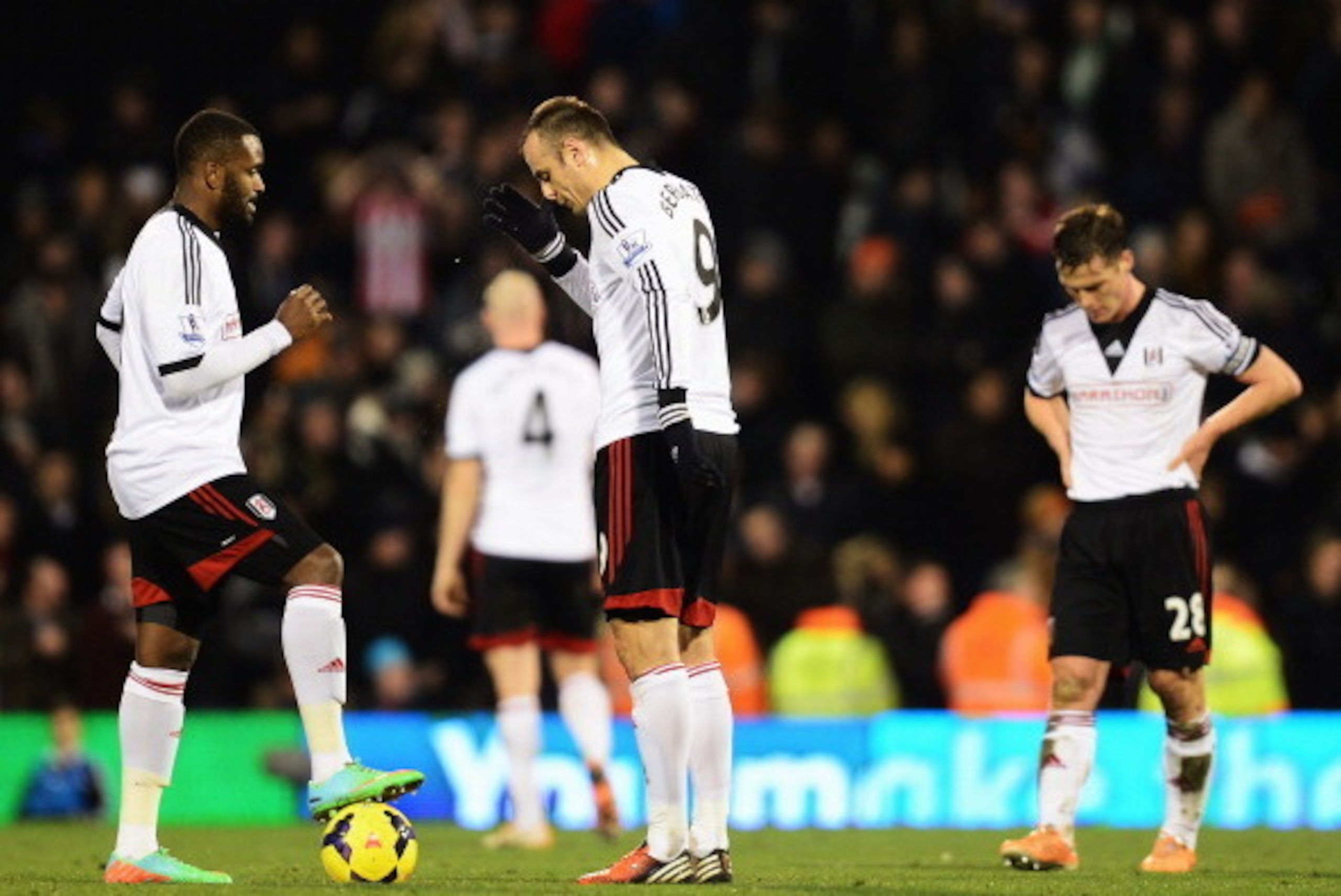 LONDON, ENGLAND - JANUARY 11:  (L-R) Fulham players Darren Bent, Dimitar Berbatov and Scott Parker react as they prepare to restart the game after conceding a goal during the Barclays Premier League match between Fulham and Sunderland at Craven Cottage on