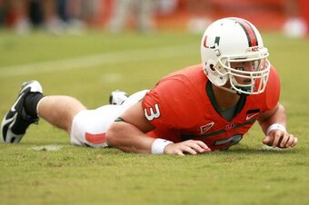 CORAL GABLES, FL - OCTOBER 13:  Quarterback Kyle Wright #3 of the Miami Hurricanes is slow to get up after being hit while throwing a pass against the Georgia Tech Yellow Jackets at the Orange Bowl on October 13, 2007 in Coral Gables, Florida. Georgia Tec
