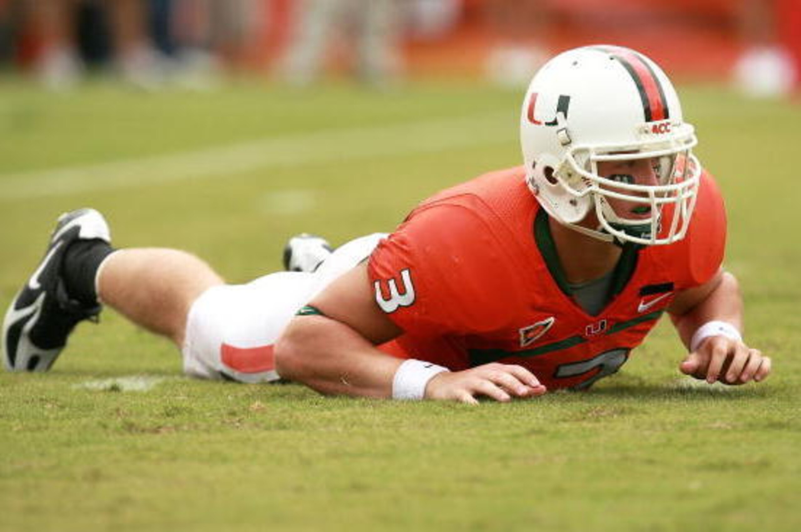 CORAL GABLES, FL - OCTOBER 13:  Quarterback Kyle Wright #3 of the Miami Hurricanes is slow to get up after being hit while throwing a pass against the Georgia Tech Yellow Jackets at the Orange Bowl on October 13, 2007 in Coral Gables, Florida. Georgia Tec