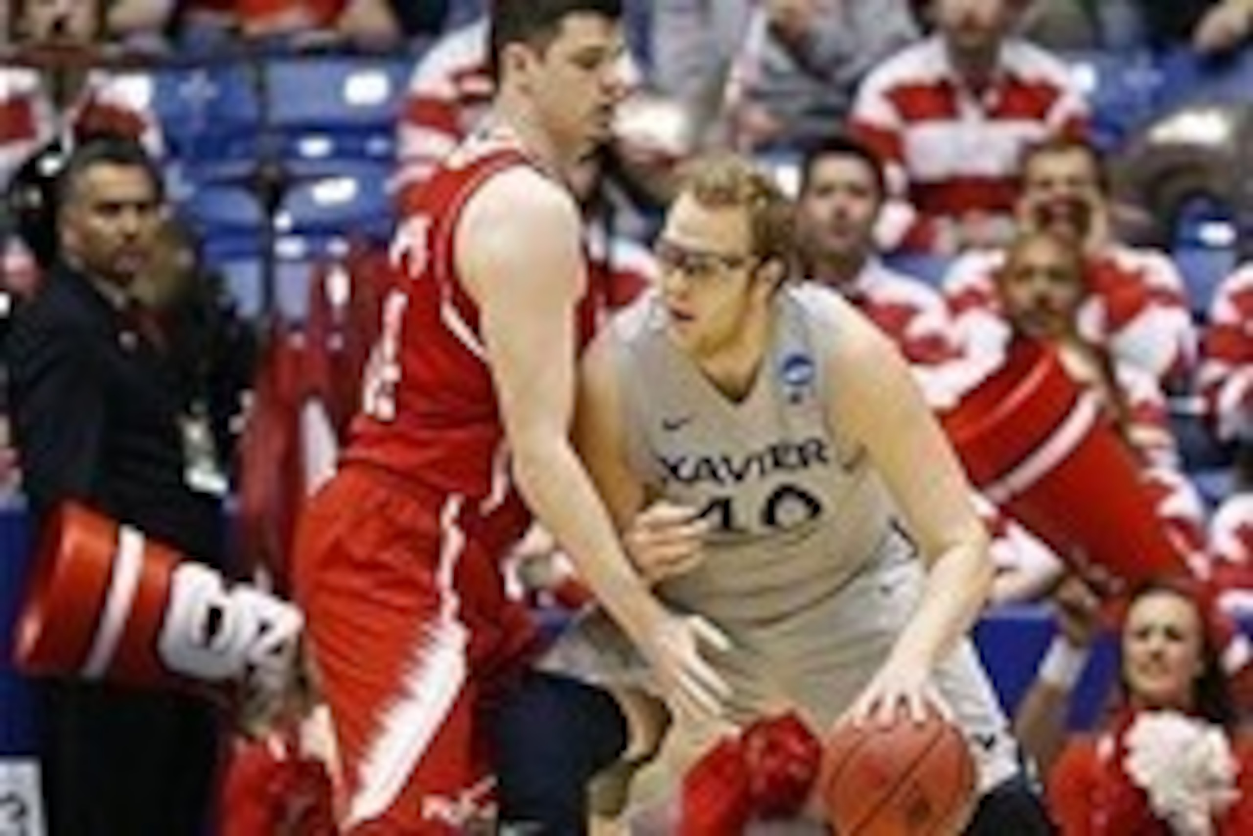 Mar 18, 2014; Dayton, OH, USA; Xavier Musketeers center Matt Stainbrook (40) goes up against North Carolina State Wolfpack center Jordan Vandenberg (14) in the first half of a college basketball game during the first round of the 2014 NCAA Tournament at U