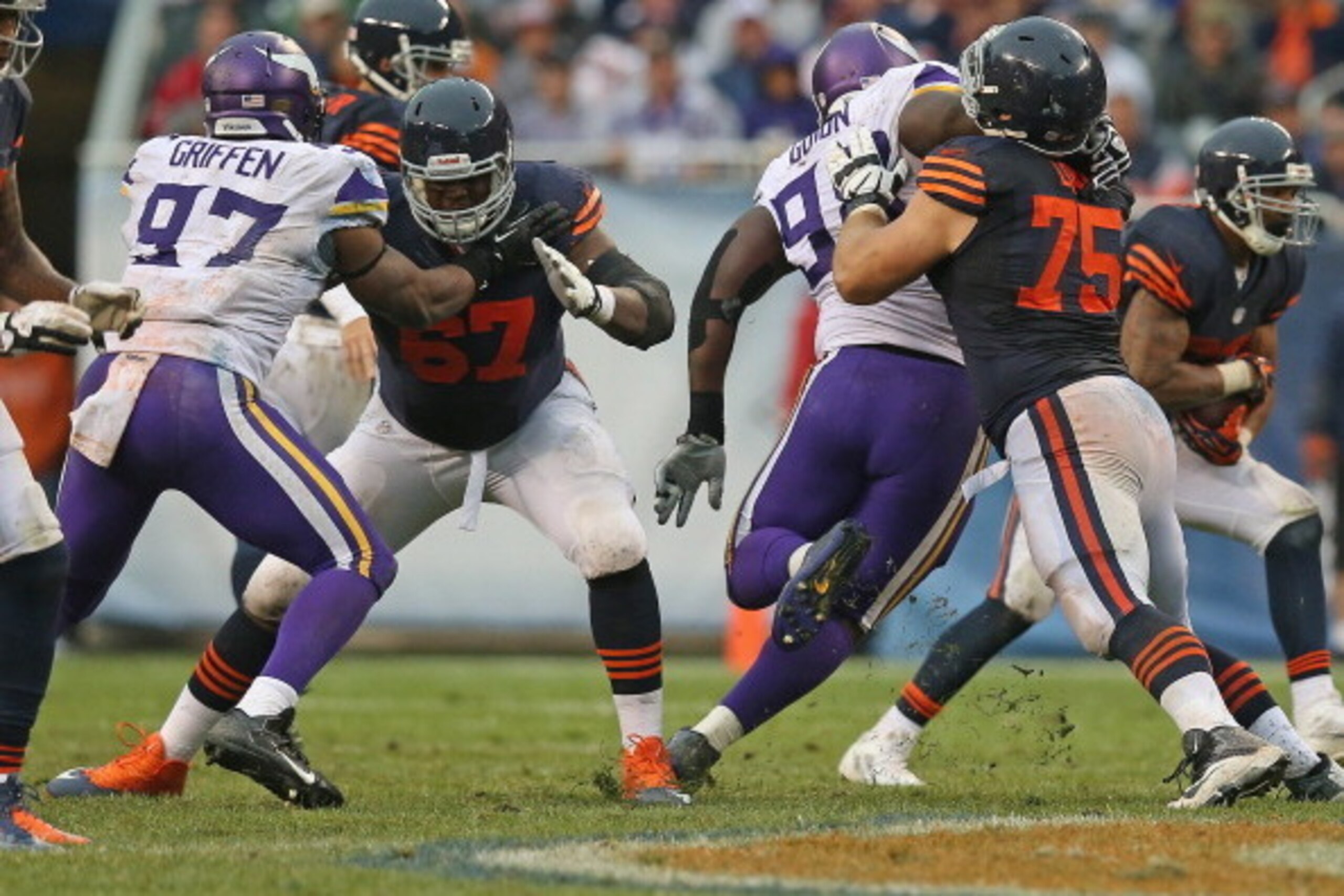 CHICAGO, IL - SEPTEMBER 15:  Jordan Mills #67 and Kyle Long #75 of the Chicago Bears block Everson Griffen #97 and Letroy Guion #98 of the Minnesota Vikings at Soldier Field on September 15, 2013 in Chicago, Illinois. The Bears defeated the Vikings 31-30.