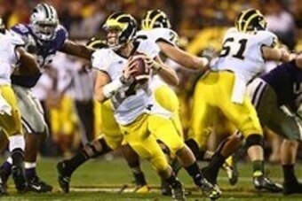 Dec 28, 2013; Tempe, AZ, USA; Michigan Wolverines quarterback Shane Morris (7) scrambles in the first half against the Kansas State Wildcats during the Buffalo Wild Wings Bowl at Sun Devil Stadium. Mandatory Credit: Mark J. Rebilas-USA TODAY Sports