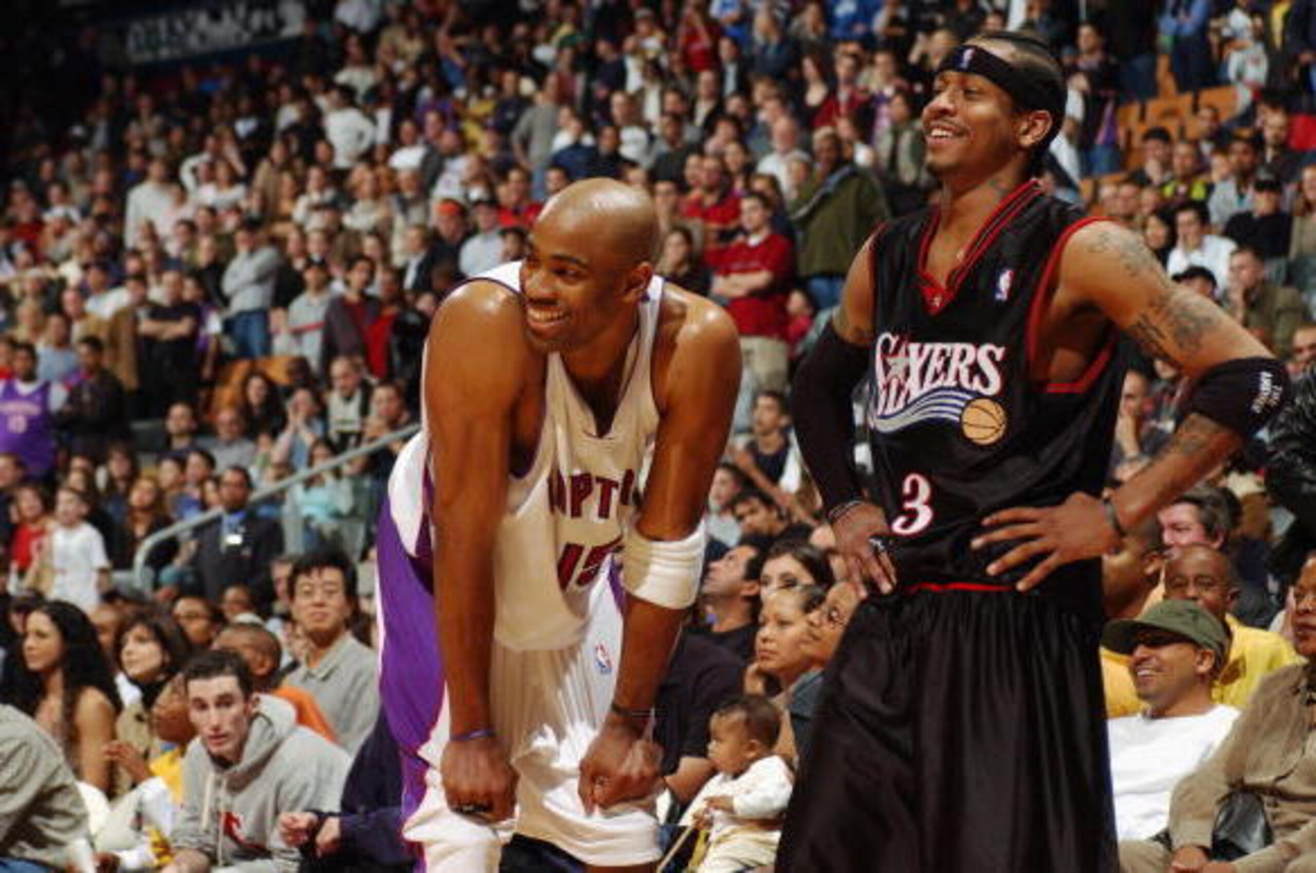 TORONTO - OCTOBER 13:  Vince Carter #15 of the Toronto Raptors and Allen Iverson #3 of the Philadelphia 76ers smile during a preseason game on October 13, 2002 at Air Canada Centre in Toronto, Canada. The Sixers won 105-101 in overtime.  NOTE TO USER: Use
