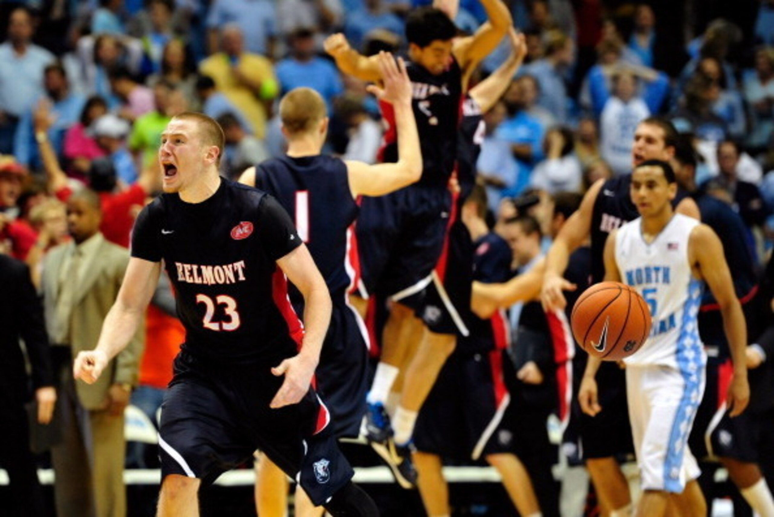 CHAPEL HILL, NC - NOVEMBER 17:  Craig Bradshaw #23 of the Belmont Bruins and teammates celebrate after a win as Marcus Paige #5 of the North Carolina Tar Heels walks off the court at the Dean Smith Center on November 17, 2013 in Chapel Hill, North Carolin