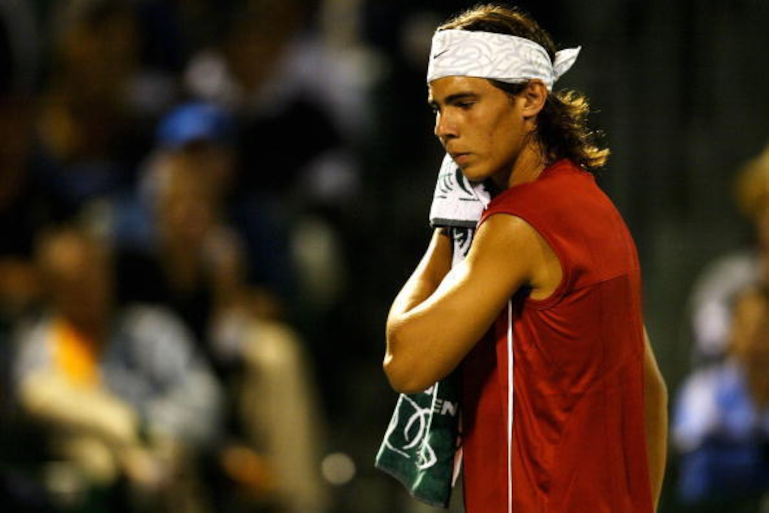 MIAMI - MARCH 28: Rafael Nadal of Spain wipes sweat off his face during his match against Roger Federer of Switzerland on March 28, 2004 during Nasdaq 100 Open at the Crandon Park Tennis Center on Key Biscayne in Miami, Florida. (Photo by Ezra Shaw/Gett MIAMI - MARCH 28: Rafael Nadal of Spain wipes sweat off his face during his match against Roger Federer of Switzerland on March 28, 2004 during Nasdaq 100 Open at the Crandon Park Tennis Center on Key Biscayne in Miami, Florida. (Photo by Ezra Shaw/Gett