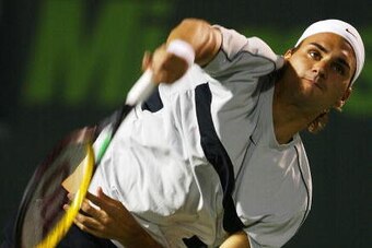 MIAMI, FLORIDA - MARCH 28:  Roger Federer of Switzerland serves to Rafael Nadal of Spain during The third round of Nasdaq 100 Open on March 28, 2004 in Miami, Florida. (Photo by Al Bello/Getty Images)