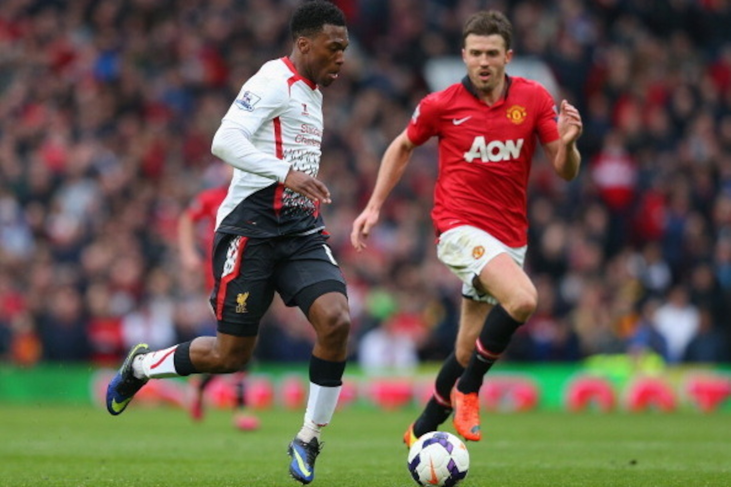 MANCHESTER, ENGLAND - MARCH 16:  Daniel Sturridge of Liverpool competes with Michael Carrick of Manchester United during the Barclays Premier League match between Manchester United and Liverpool at Old Trafford on March 16, 2014 in Manchester, England.  (