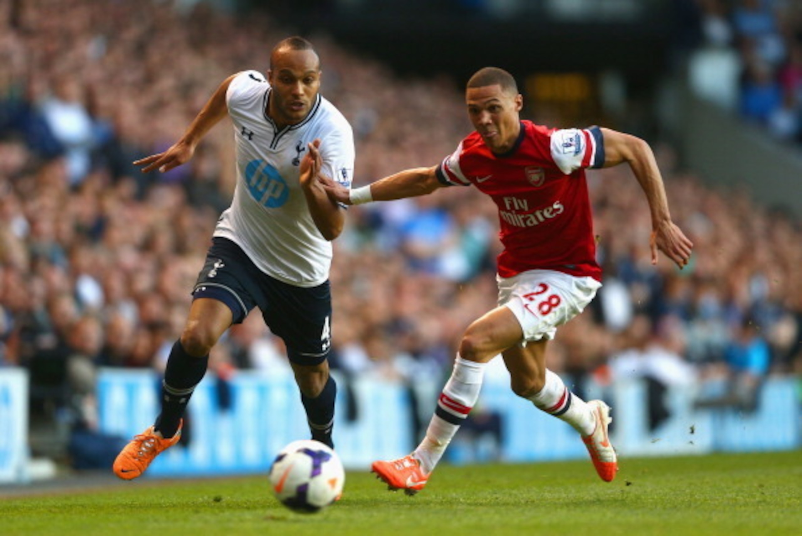 LONDON, ENGLAND - MARCH 16:  Kieran Gibbs of Arsenal and Younes Kaboul of Tottenham Hotspur battle for the ball during the Barclays Premier League match between Tottenham Hotspur and Arsenal at White Hart Lane on March 16, 2014 in London, England.  (Photo