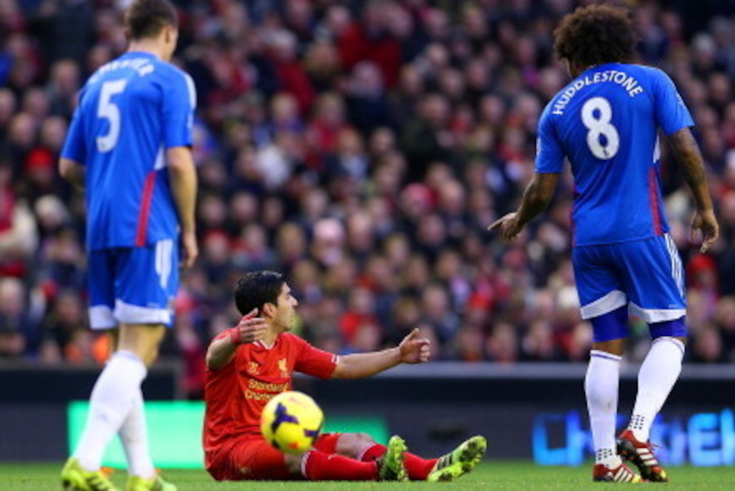 LIVERPOOL, ENGLAND - JANUARY 01:  Luis Suarez of Liverpool appeals to the referee after Alex Bruce of Hull City (L) brings him down during the Barclays Premier League match between Liverpool and Hull City at Anfield on January 1, 2014 in Liverpool, Englan