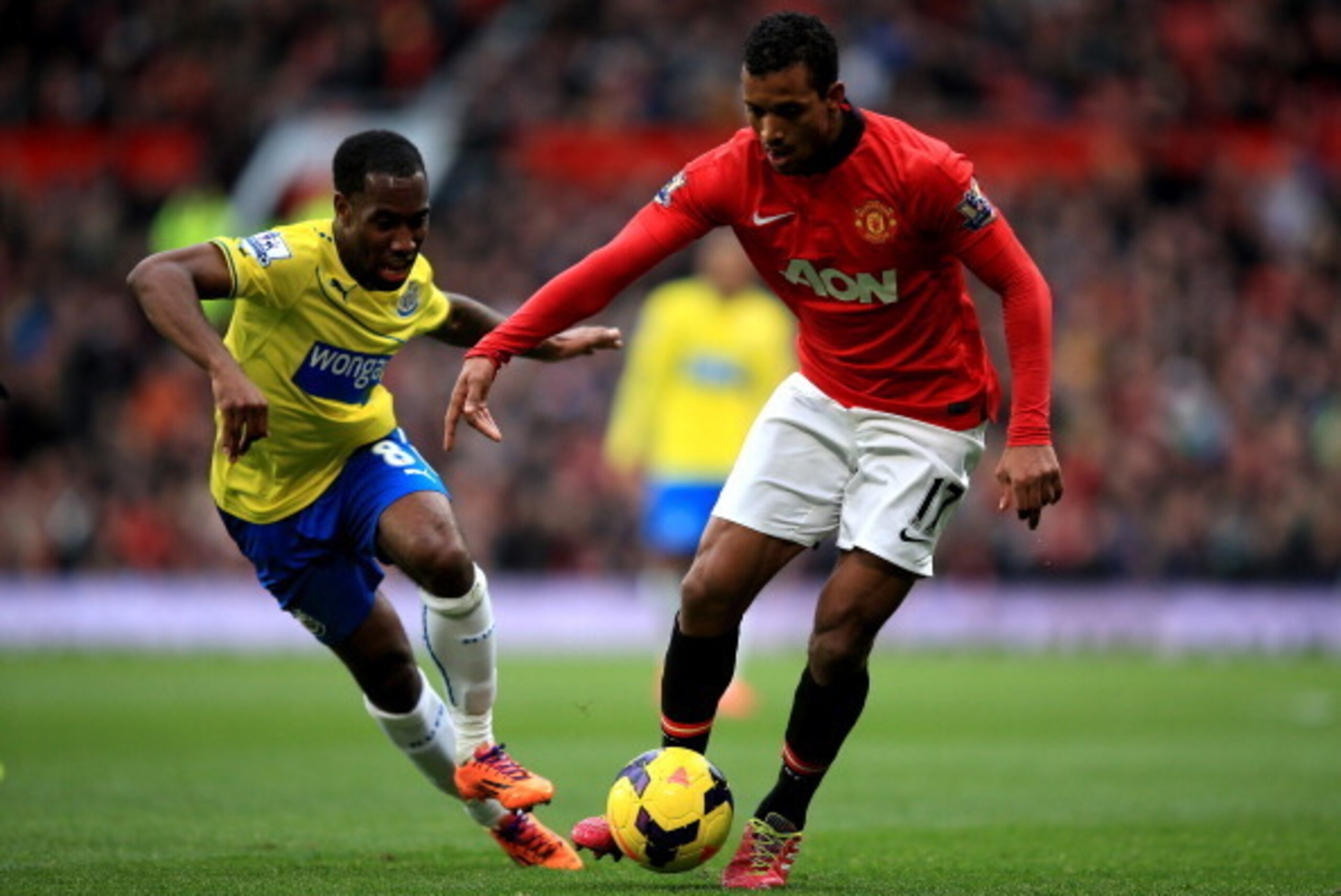 MANCHESTER, ENGLAND - DECEMBER 07:  Nani of Manchester United is pursued by Vurnon Anita of Newcastle during the Barclays Premier League match between Manchester United and Newcastle United at Old Trafford on December 7, 2013 in Manchester, England.  (Pho