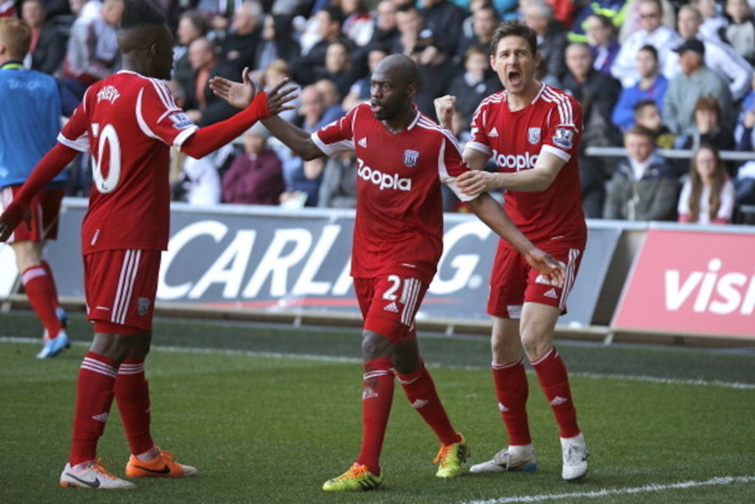 SWANSEA WALES - MARCH 15: West Bromwich Albion goalscorer Youssouf Mulumbu (C) celebrates his goal with Thievy Bifouma and Zoltan Gera (R) during the Barclays Premier League match between Swansea City and West Bromwich Albion at The Liberty Stadium on Mar