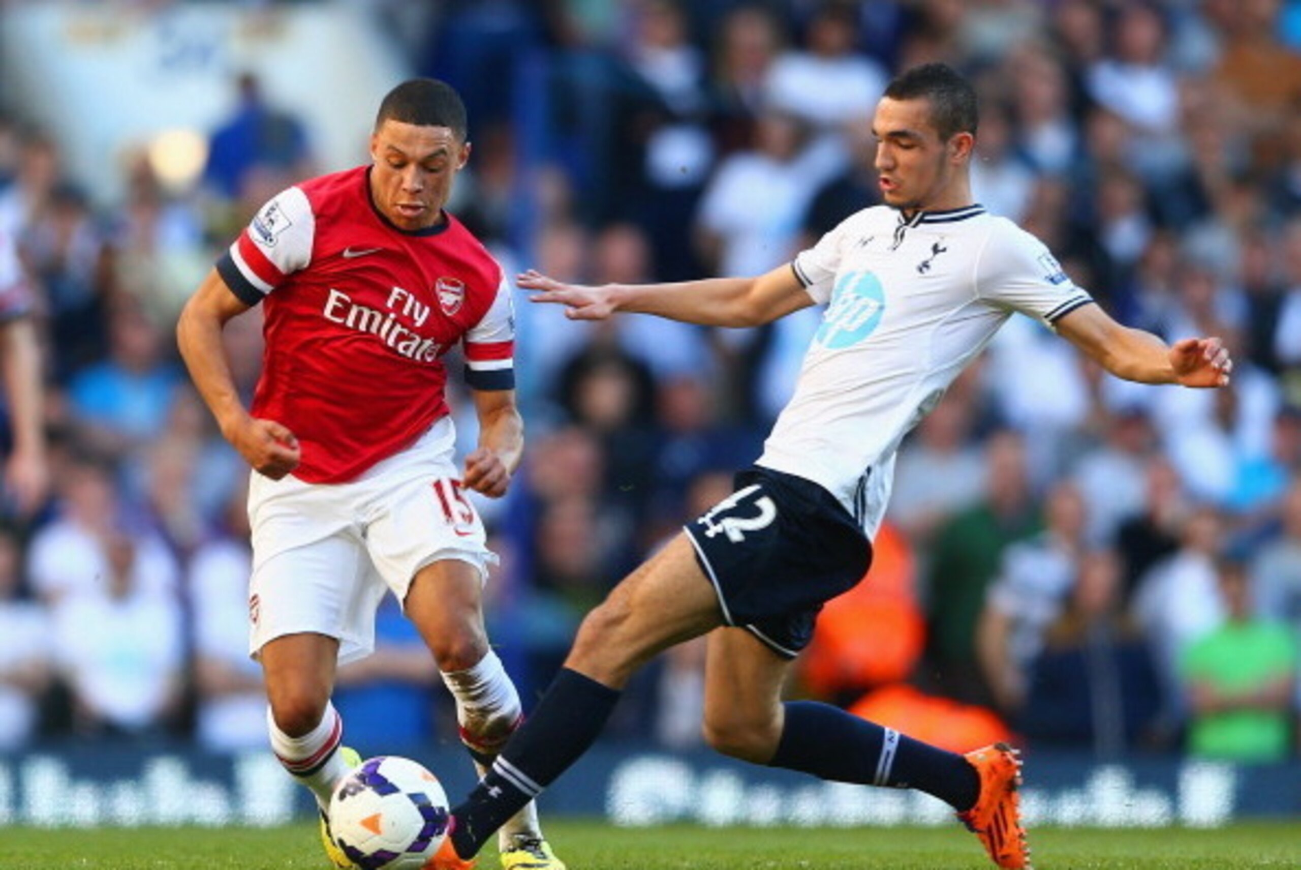 LONDON, ENGLAND - MARCH 16:  Alex Oxlade-Chamberlain of Arsenal evades the tackle of Nabil Bentaleb of Tottenham Hotspur during the Barclays Premier League match between Tottenham Hotspur and Arsenal at White Hart Lane on March 16, 2014 in London, England