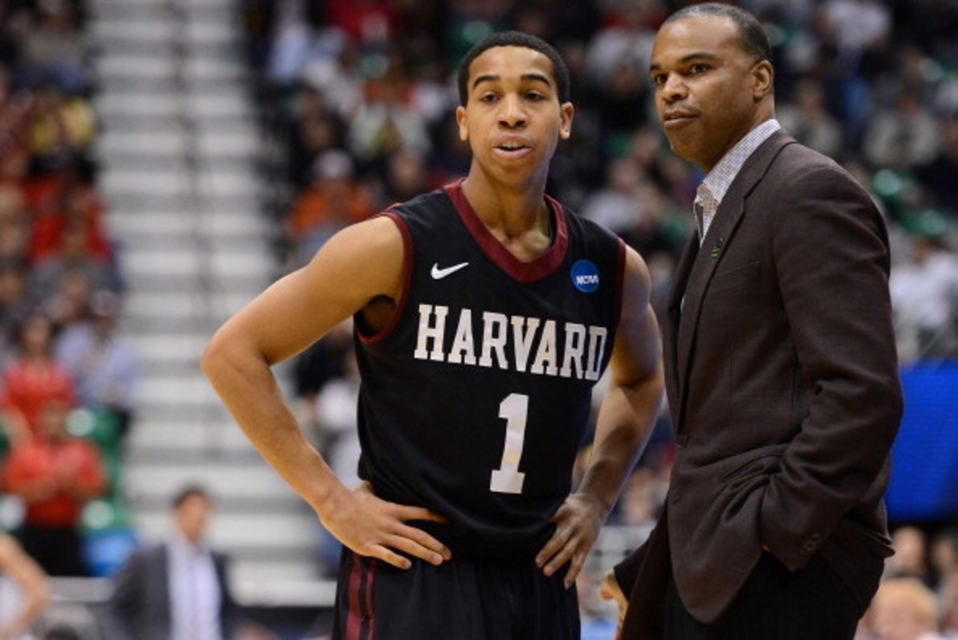 SALT LAKE CITY, UT - MARCH 21:  Head coach Tommy Amaker of the Harvard Crimson talks with Siyani Chambers #1 in the first half against the New Mexico Lobos during the second round of the 2013 NCAA Men's Basketball Tournament at EnergySolutions Arena on Ma
