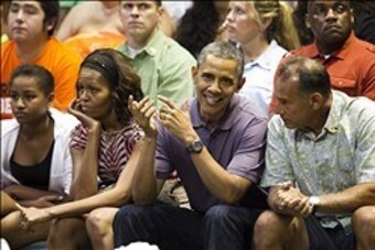 Dec 22, 2013; Honolulu, HI, USA; President Barack Obama, center, talks with friend Bobby Titcomb as Michelle Obama, second from left, and daughter, Sasha, sit along them at Stan Sheriff Center. The First Family attended the Oregon State Beavers vs Akron Z