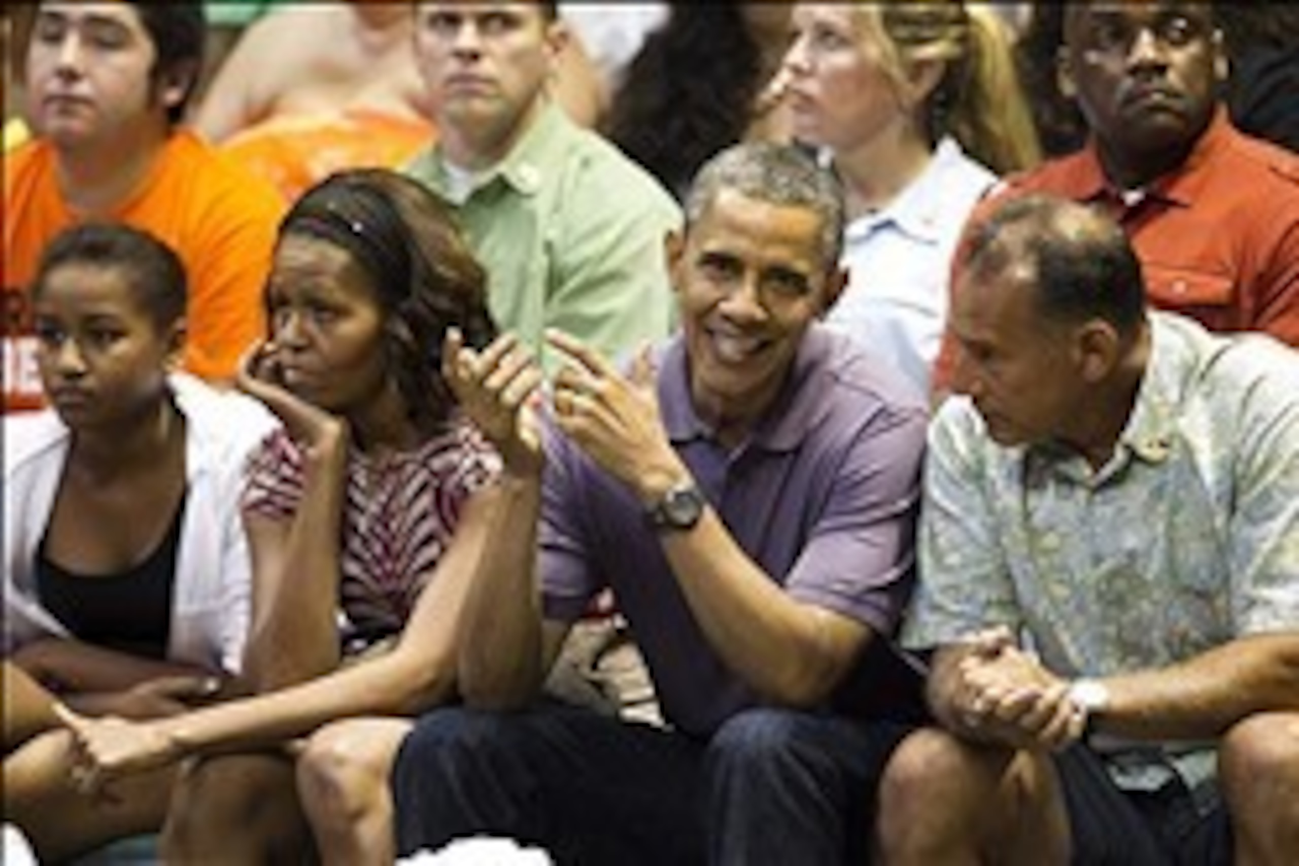 Dec 22, 2013; Honolulu, HI, USA; President Barack Obama, center, talks with friend Bobby Titcomb as Michelle Obama, second from left, and daughter, Sasha, sit along them at Stan Sheriff Center. The First Family attended the Oregon State Beavers vs Akron Z