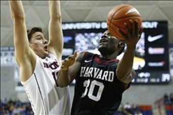 Jan 8, 2014; Storrs, CT, USA; Harvard Crimson forward Kyle Casey (30) shoots against Connecticut Huskies forward Tyler Olander (10) in the second half at Harry A. Gampel Pavilion. UConn defeated Harvard 61-56. Mandatory Credit: David Butler II-USA TODAY S