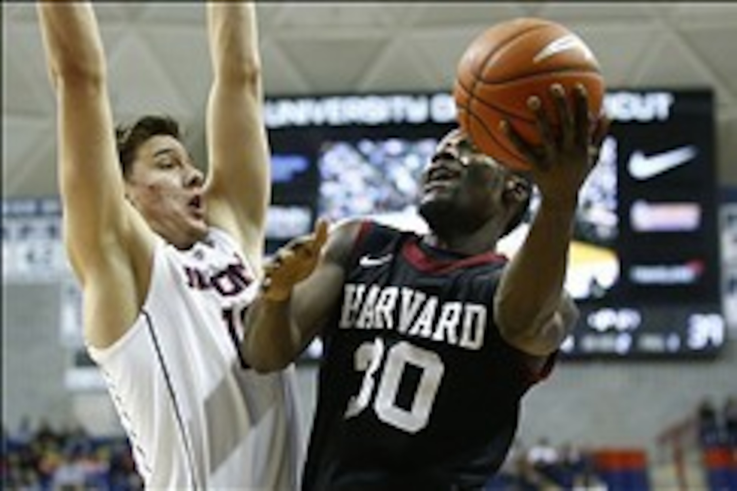 Jan 8, 2014; Storrs, CT, USA; Harvard Crimson forward Kyle Casey (30) shoots against Connecticut Huskies forward Tyler Olander (10) in the second half at Harry A. Gampel Pavilion. UConn defeated Harvard 61-56. Mandatory Credit: David Butler II-USA TODAY S