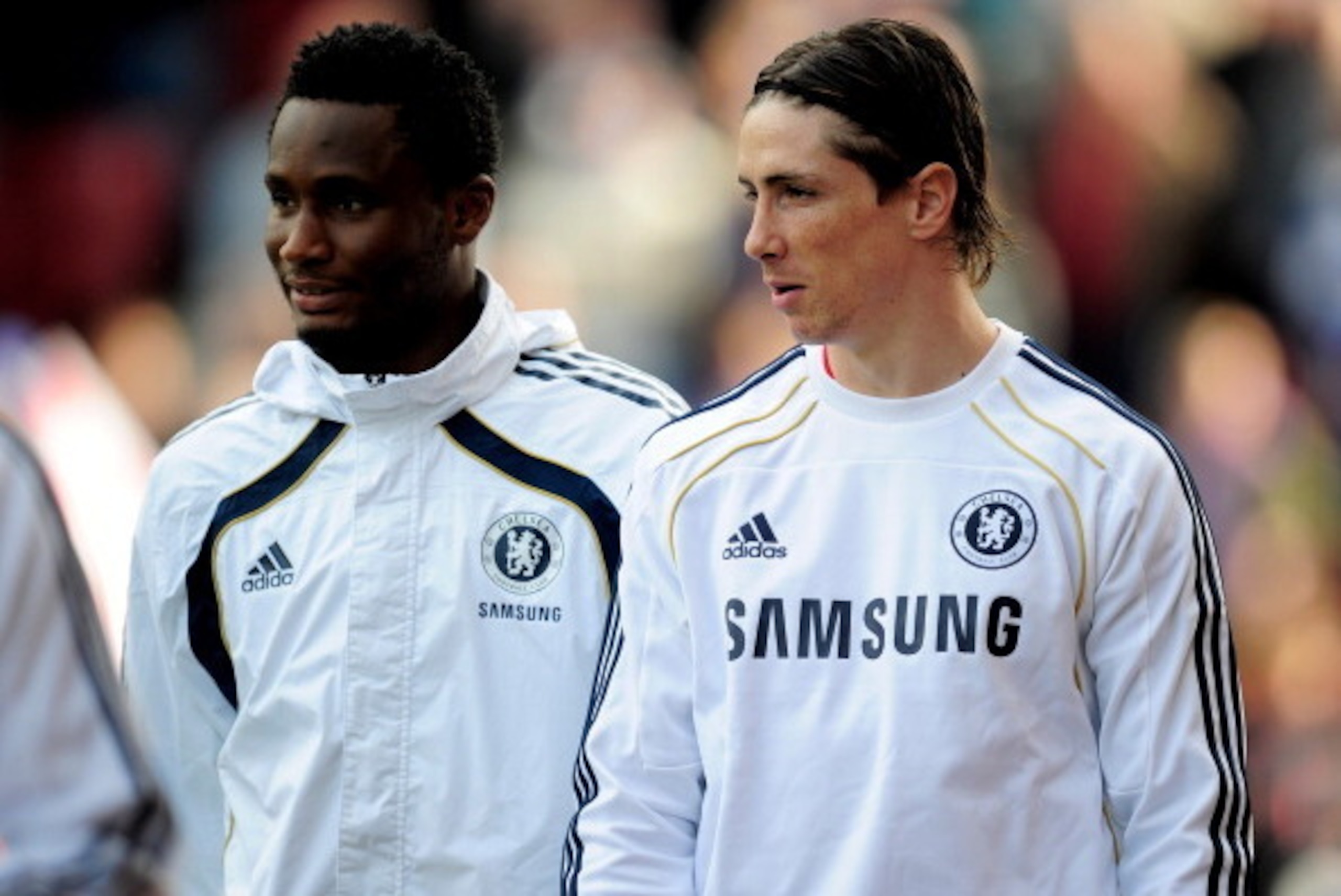 STOKE ON TRENT, ENGLAND - APRIL 02:   Fernando Torres of Chelsea heads for the bench as a substitute with team mate John Obi Mikel (L) during the Barclays Premier League match between Stoke City and Chelsea at the Britannia Stadium on April 2, 2011 in Sto