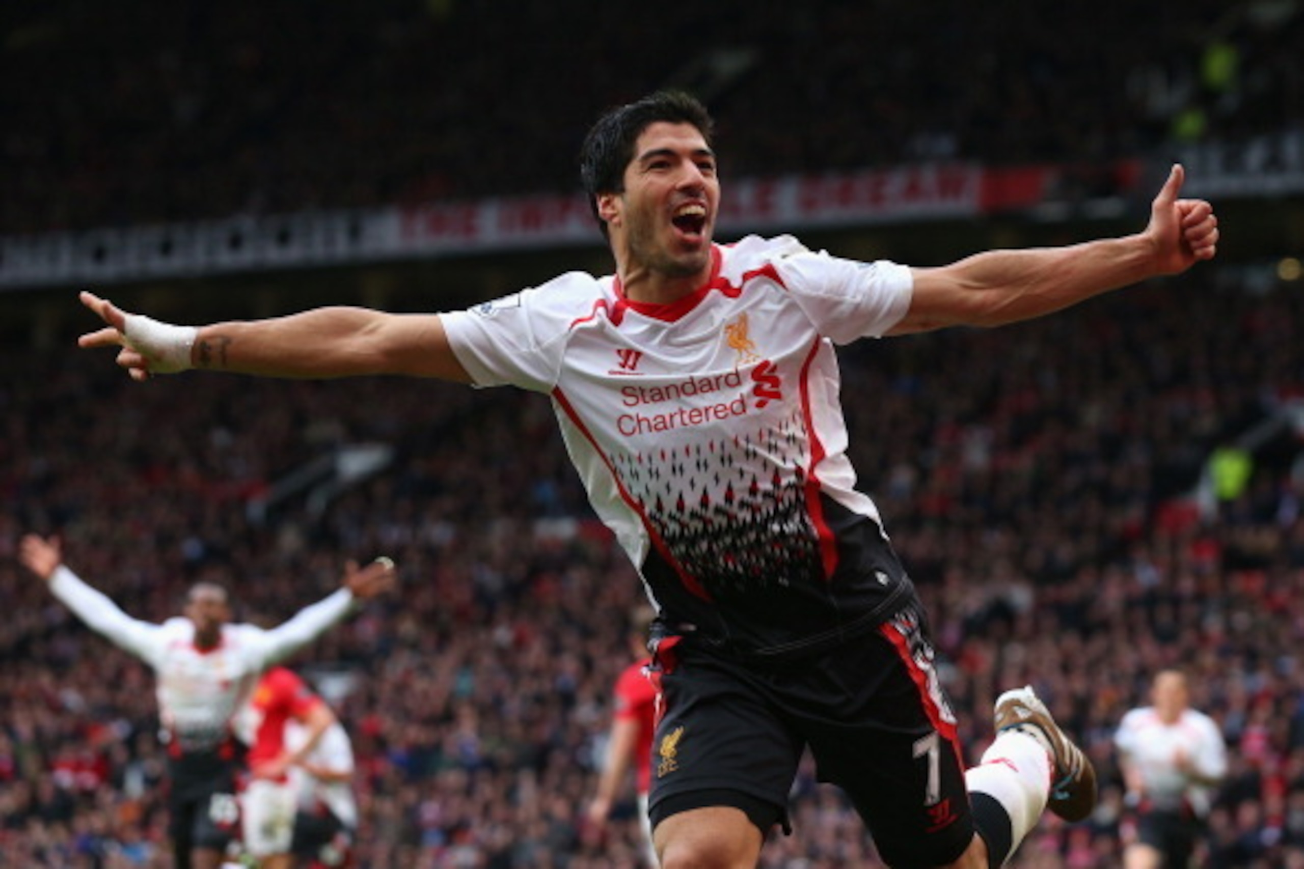 MANCHESTER, ENGLAND - MARCH 16:  Luis Suarez of Liverpool celebrates scoring his team's third goal during the Barclays Premier League match between Manchester United and Liverpool at Old Trafford on March 16, 2014 in Manchester, England.  (Photo by Alex L