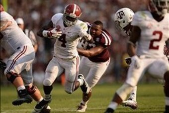 Sep 14, 2013; College Station, TX, USA; Texas A&M Aggies defensive lineman Alonzo Williams (83) tackles Alabama Crimson Tide running back T.J. Yeldon (4) during the second half at Kyle Field. Mandatory Credit: Thomas Campbell-USA TODAY Sports