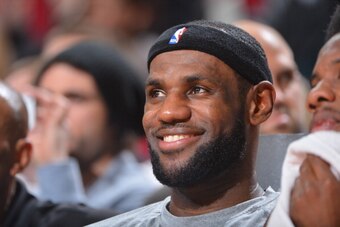 HOUSTON, TX - MARCH 4: LeBron James #6 of the Miami Heat smiles on the bench during the game against the Houston Rockets at the Toyota Center March 4, 2014 in Houston, Texas. NOTE TO USER: User expressly acknowledges and agrees that, by downloading and or