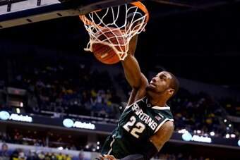 INDIANAPOLIS, IN - MARCH 16:  Branden Dawson #22 of the Michigan State Spartans dunks against the Michigan Wolverines during the 2014 Big Ten Men's Championship at Bankers Life Fieldhouse on March 16, 2014 in Indianapolis, Indiana.  (Photo by Andy Lyons/G