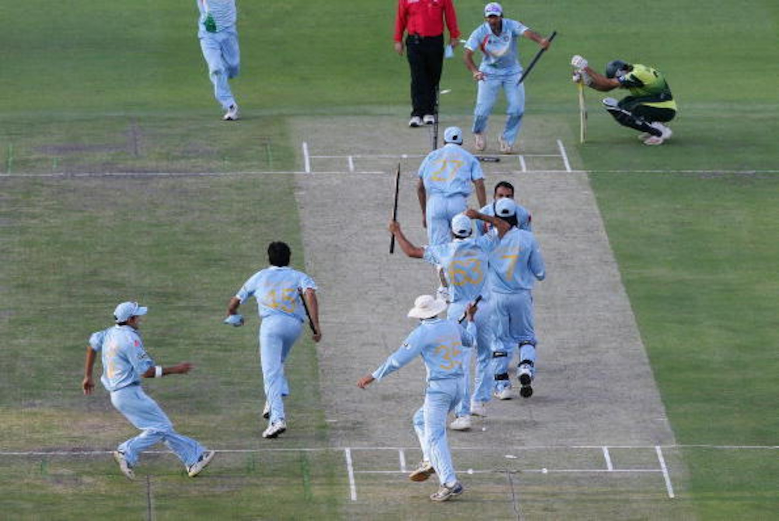 JOHANNESBURG, SOUTH AFRICA - SEPTEMBER 24:  The Indian Team celebrate their win with Misbah-ul-Haq looking on after the Twenty20 Championship Final match between Pakistan and India at The Wanderers Stadium on September 24, 2007 in Johannesburg, South Afri