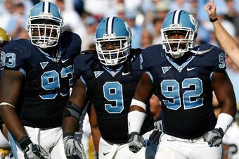 CHAPEL HILL, NC - NOVEMBER 08:  Cam Thomas #93, Marvin Austin #9 and E.J. Wilson #92 of the North Carolina Tar Heels celebrate after a defensive stop against the Georgia Tech Yellow Jackets during the game at Kenan Stadium on November 8, 2008 in Chapel Hi