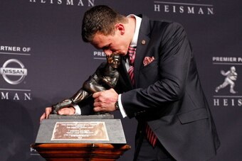 NEW YORK, NY - DECEMBER 08:   Quarterback Johnny Manziel of the Texas A&M University Aggies kisses the Heisman Memorial Trophy after being named the 78th Heisman Memorial Trophy Award winner at a press conference after the 78th Heisman Trophy Presentation