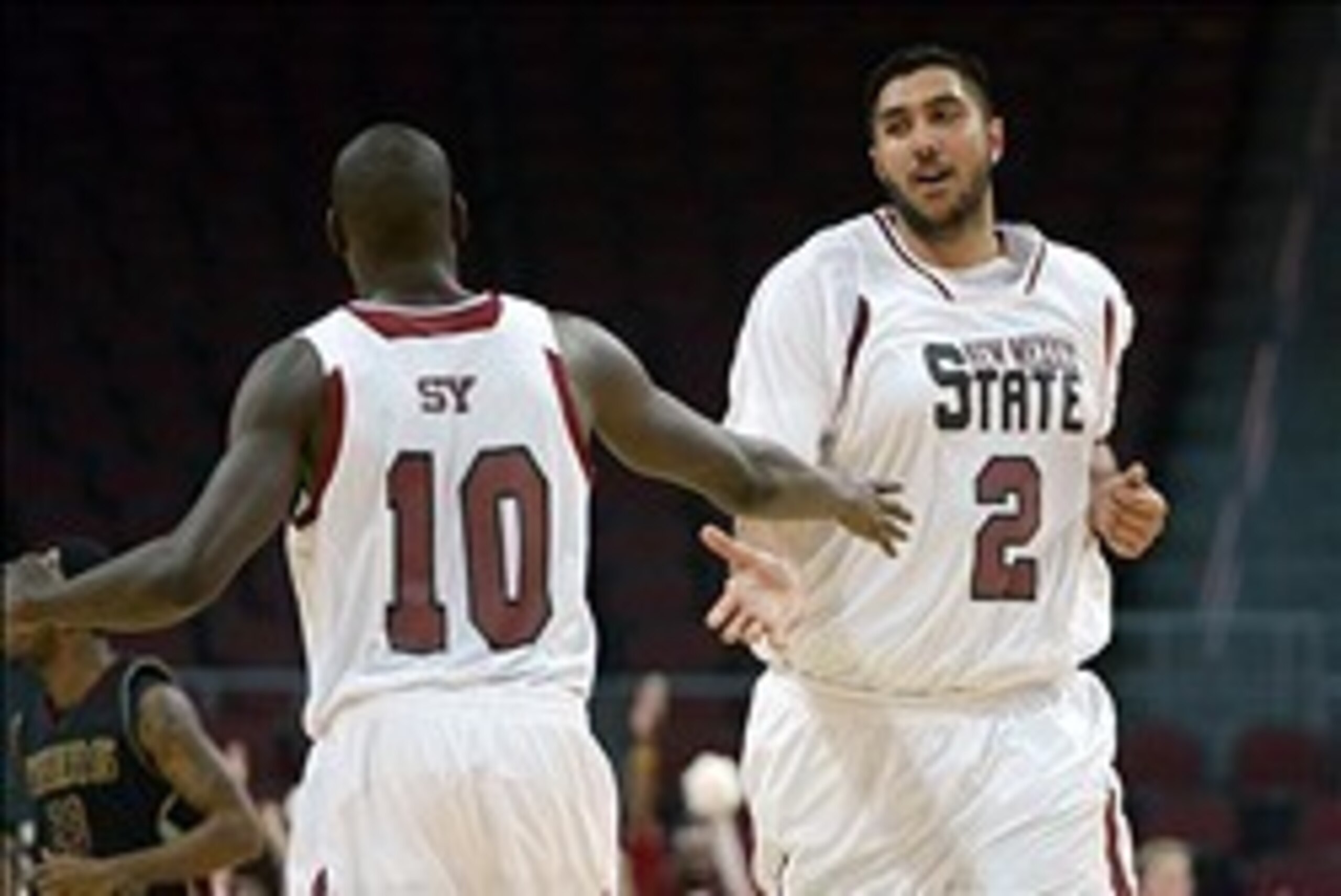 Mar 15, 2013; Las Vegas, NV, USA;  New Mexico State Aggies center Sim Bhullar (2) and forward Sy Bandja (10) celebrate against the Texas State Bobcats during the semifinals of the WAC tournament at Orleans Arena. New Mexico State defeated Texas State 74-6