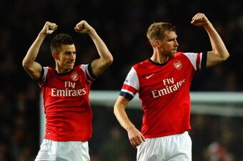 LONDON, ENGLAND - NOVEMBER 02:  Laurent Koscielny of Arsenal and Per Mertesacker of Arsenal celebrate victory at the final whistle during the Barclays Premier League match between Arsenal and Liverpool at Emirates Stadium on November 2, 2013 in London, En