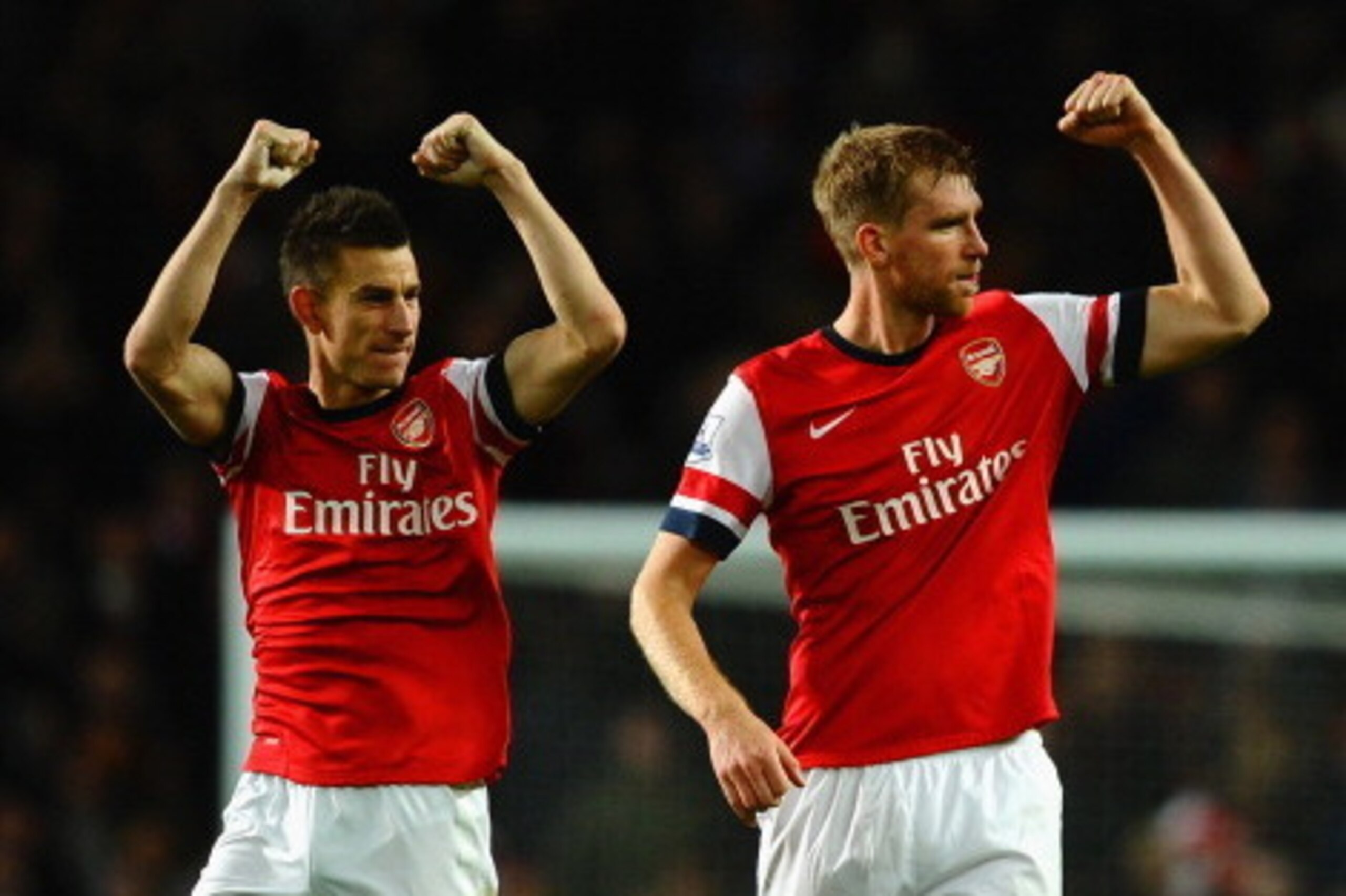LONDON, ENGLAND - NOVEMBER 02: Laurent Koscielny of Arsenal and Per Mertesacker of Arsenal celebrate victory at the final whistle during the Barclays Premier League match between Arsenal and Liverpool at Emirates Stadium on November 2, 2013 in London, En LONDON, ENGLAND - NOVEMBER 02: Laurent Koscielny of Arsenal and Per Mertesacker of Arsenal celebrate victory at the final whistle during the Barclays Premier League match between Arsenal and Liverpool at Emirates Stadium on November 2, 2013 in London, En