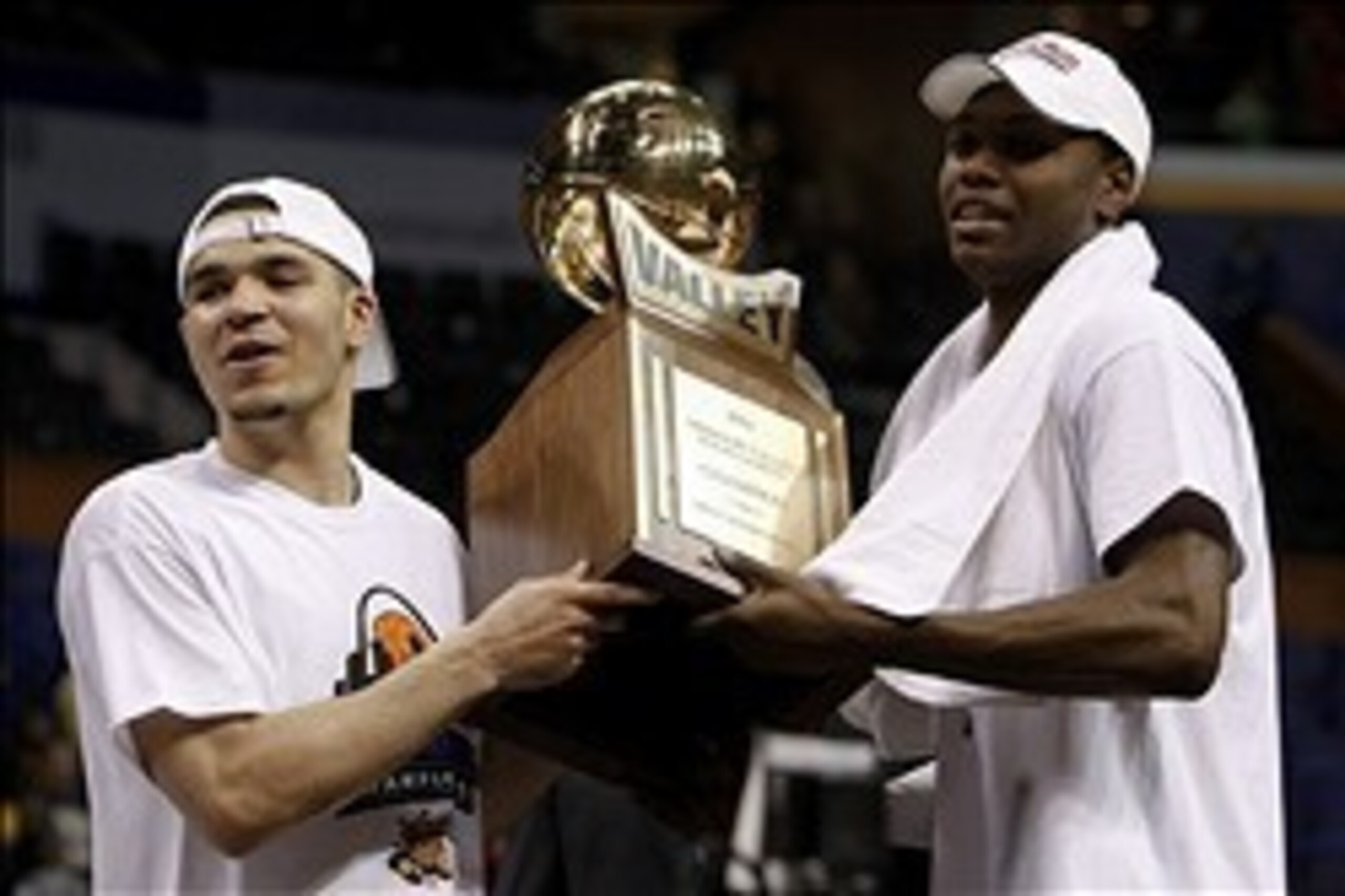 Mar 9, 2014; St. Louis, MO, USA; Wichita State Shockers guard Fred VanVleet 23) and teammate forward Cleanthony Early (11) hold the conference trophy after the championship game of the Missouri Valley Conference basketball tournament  against the Indiana 