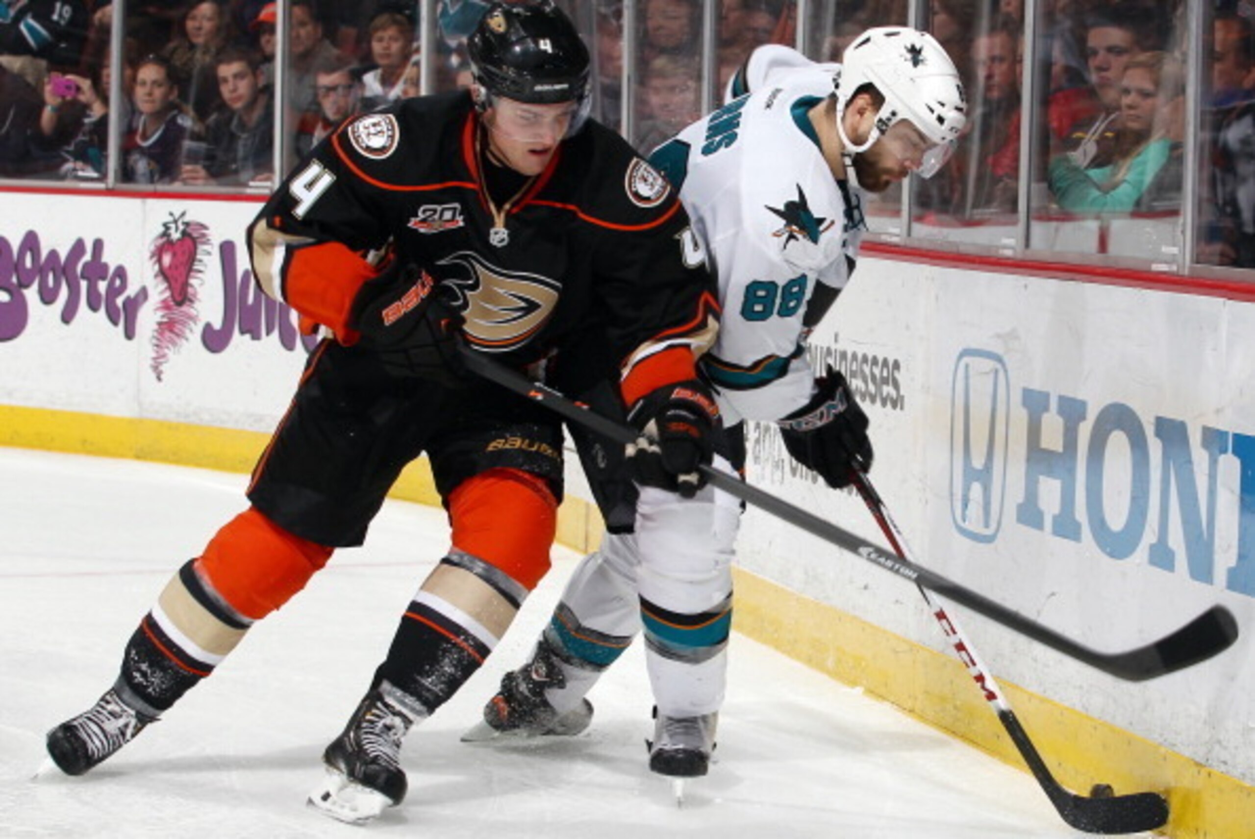ANAHEIM, CA - DECEMBER 31:  Cam Fowler #4 of the Anaheim Ducks battles for the puck against Brent Burns #88 of the San Jose Sharks on December 31, 2013 at Honda Center in Anaheim, California.  (Photo by Debora Robinson/NHLI via Getty Images)