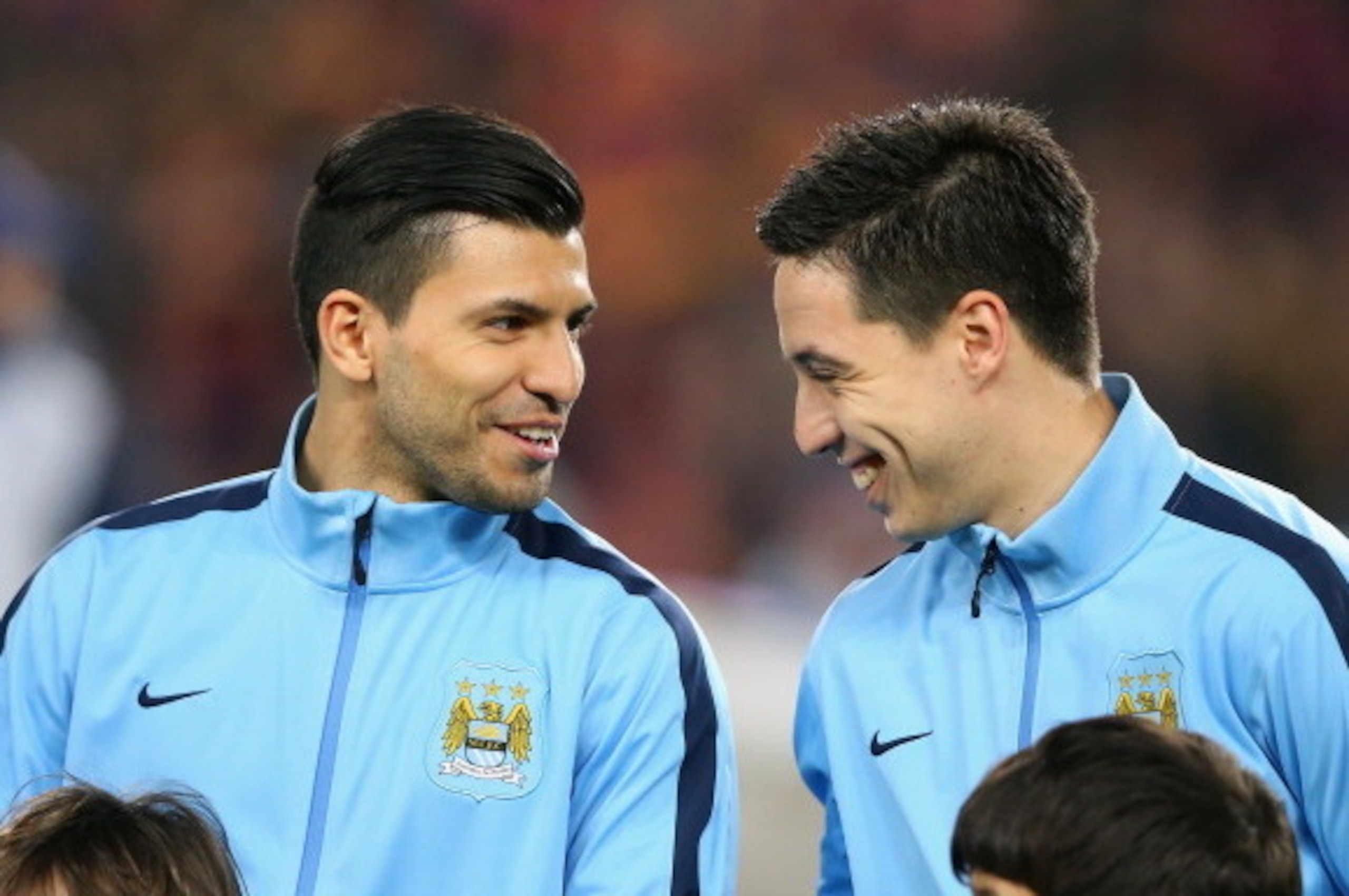 BARCELONA, SPAIN - MARCH 12:  Sergio Aguero and Samir Nasri of Manchester City share a joke prior to the UEFA Champions League Round of 16 match between FC Barcelona and Manchester City at Camp Nou on March 12, 2014 in Barcelona, Spain.  (Photo by Alex Li