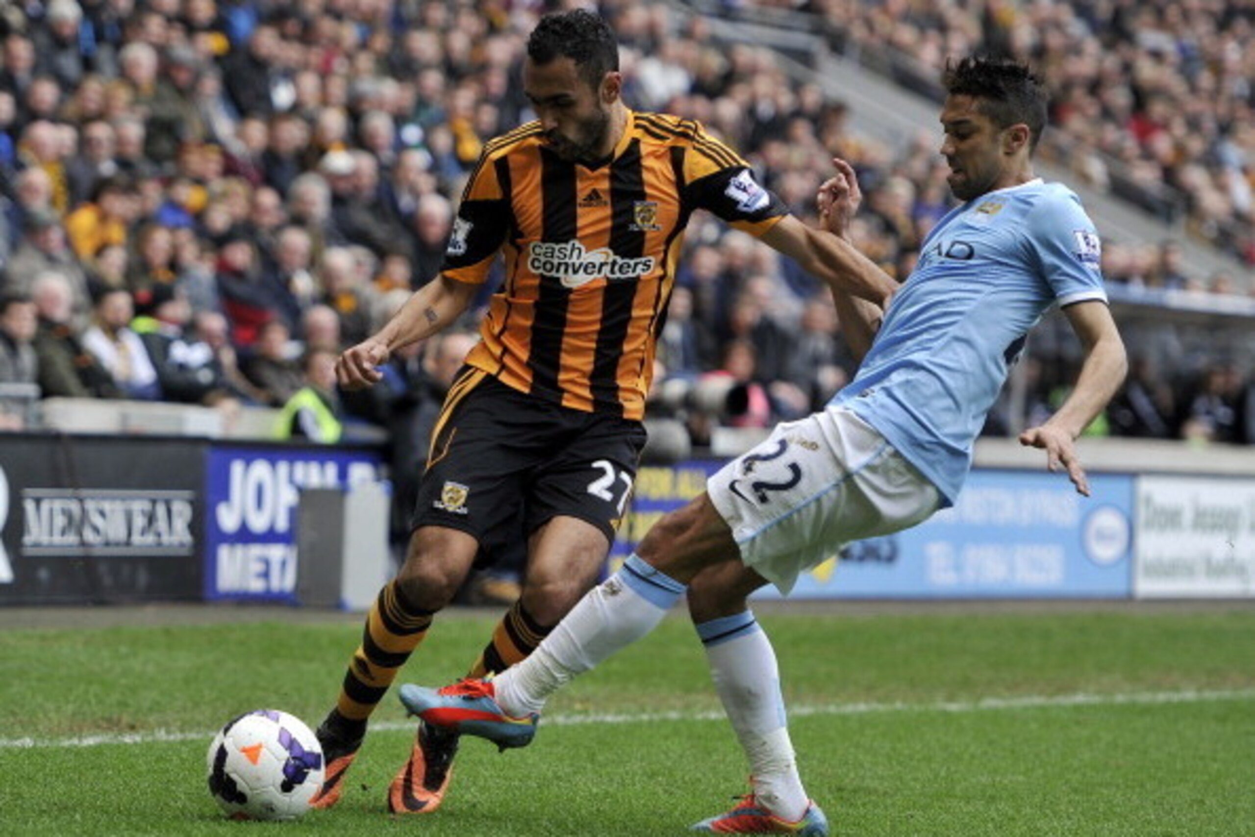 HULL, ENGLAND - MARCH 15:  Ahmed Elmohamady (L) of Hull City is tackled by Gael Clichy of Manchester City during the Barclays Premier League match between Hull City and Manchester City at the KC Stadium on March 15, 2014 in Hull, England. (Photo by Clint 