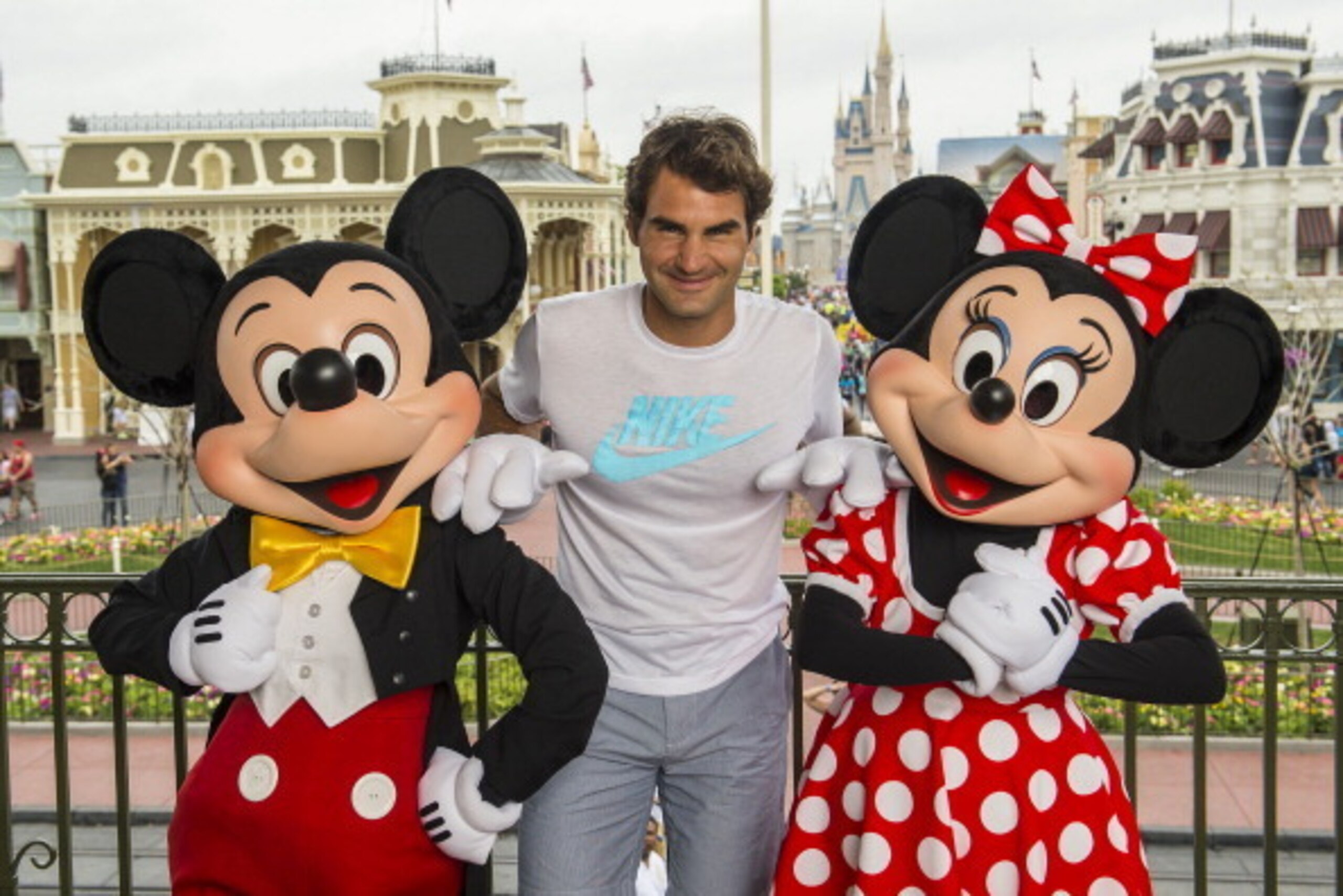 LAKE BUENA VISTA, FL - MARCH 17:  In this handout photo provided by Diseny Parks, tennis legend Roger Federer poses with Mickey and Minnie Mouse at the Magic Kingdom park March 17, 2014 in Lake Buena Vista, Florida.  The Swiss-born Federer holds the men's